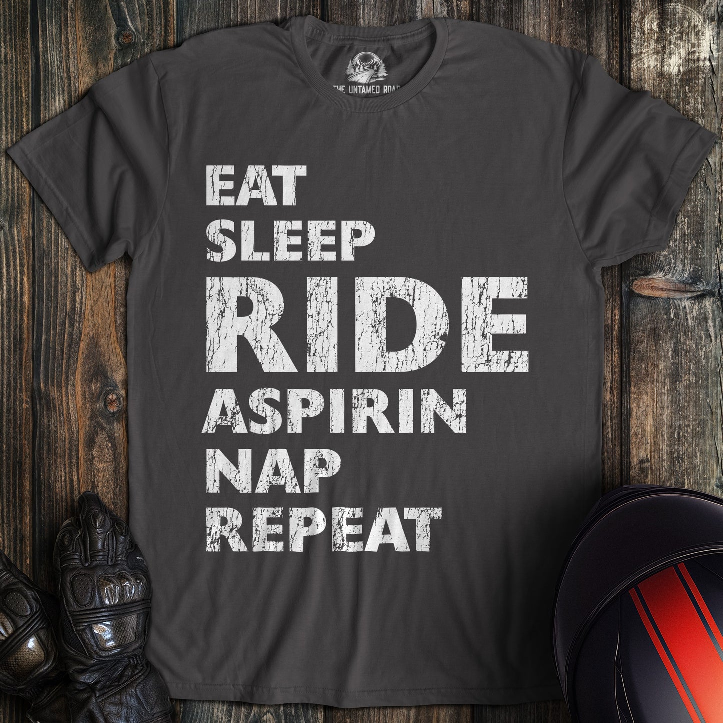 A charcoal colored t-shirt with the words "eat sleep ride" printed on the front.