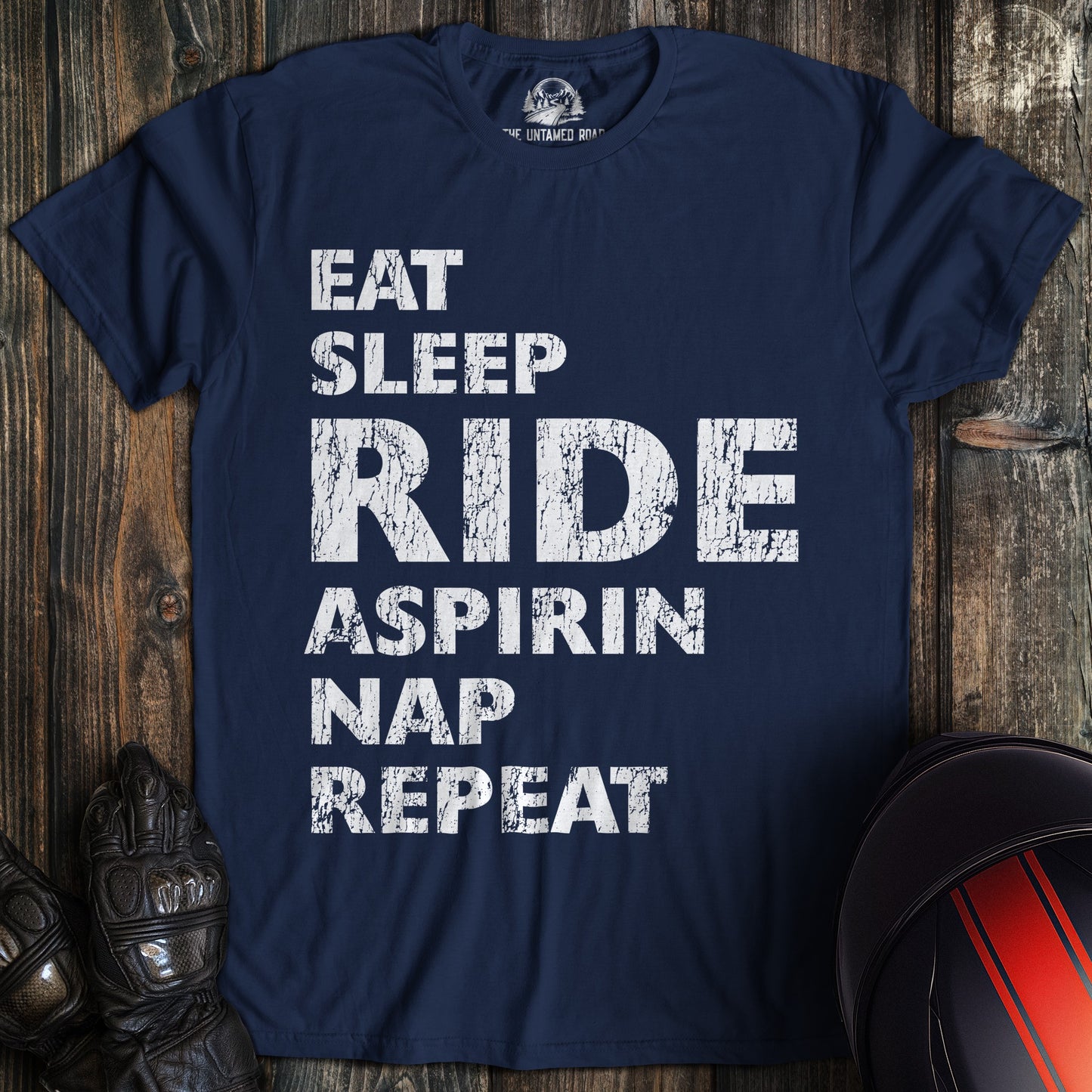 A navy colored t-shirt with the words "eat sleep ride" printed on the front.