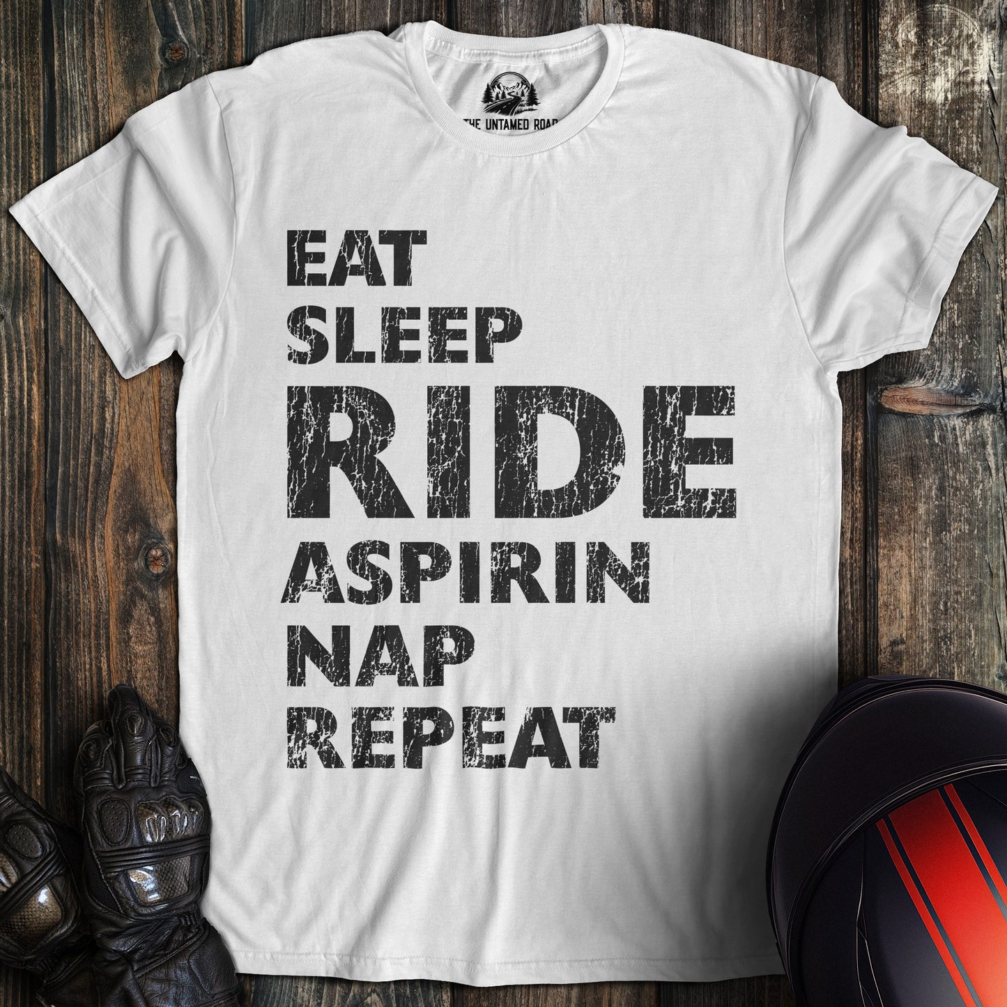 A white colored t-shirt with the words "eat sleep ride" printed on the front.