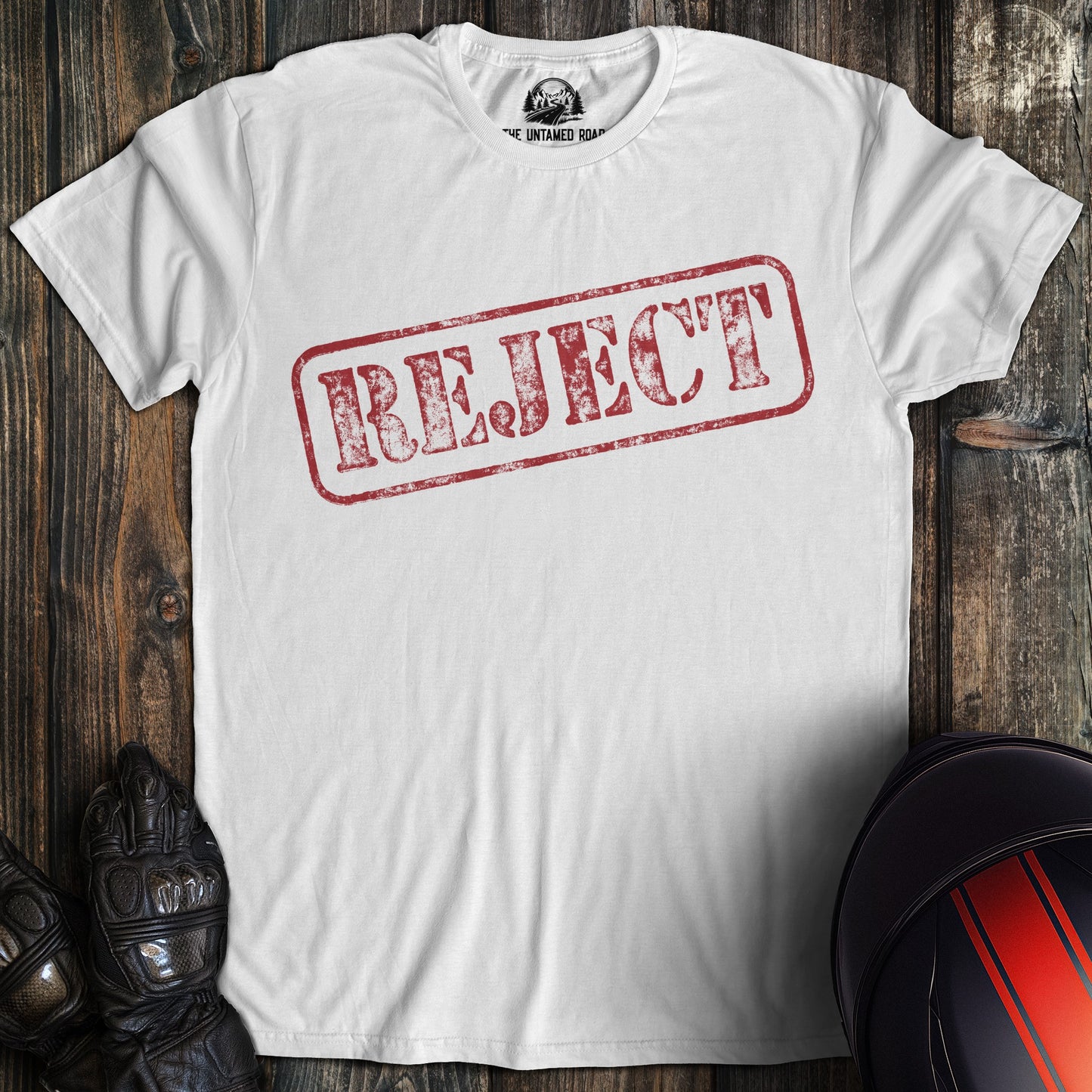 A white colored t-shirt with the words "reject" printed on the front.