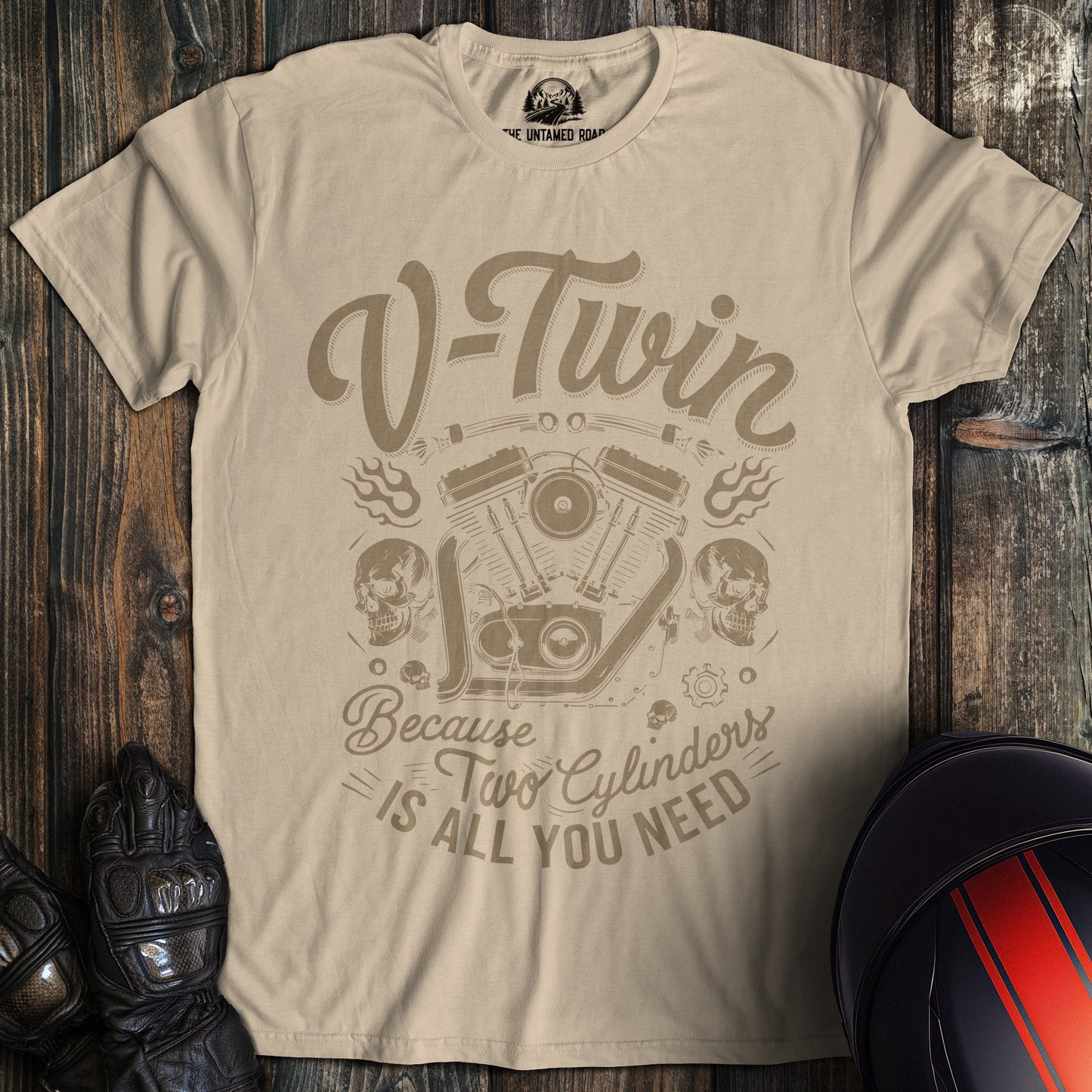 A sand colored t-shirt with the words "two cylinders all you need" printed on the front.