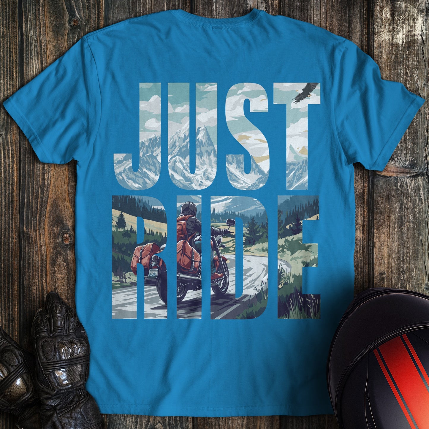 A sapphire blue colored t-shirt with the words "just ride" printed on the back.