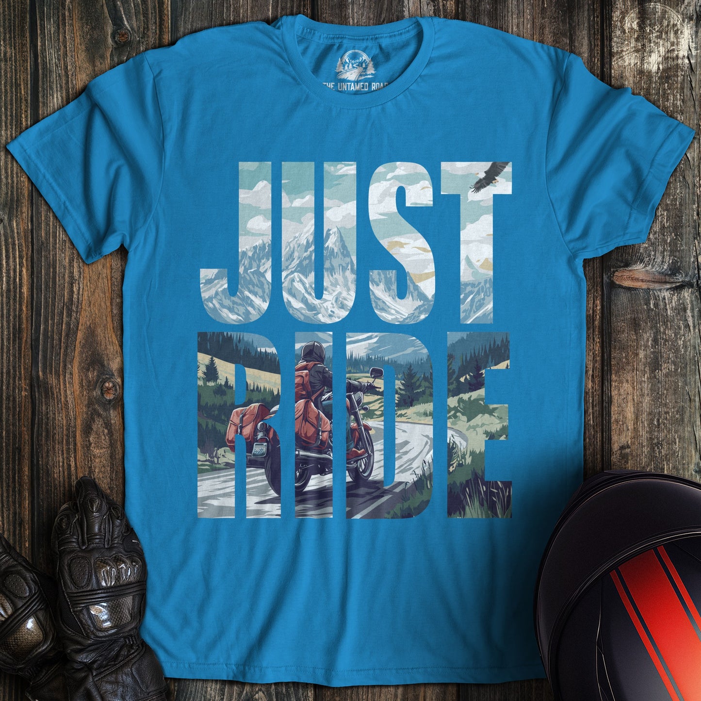 A sapphire blue colored t-shirt with the words "just ride" printed on the front.