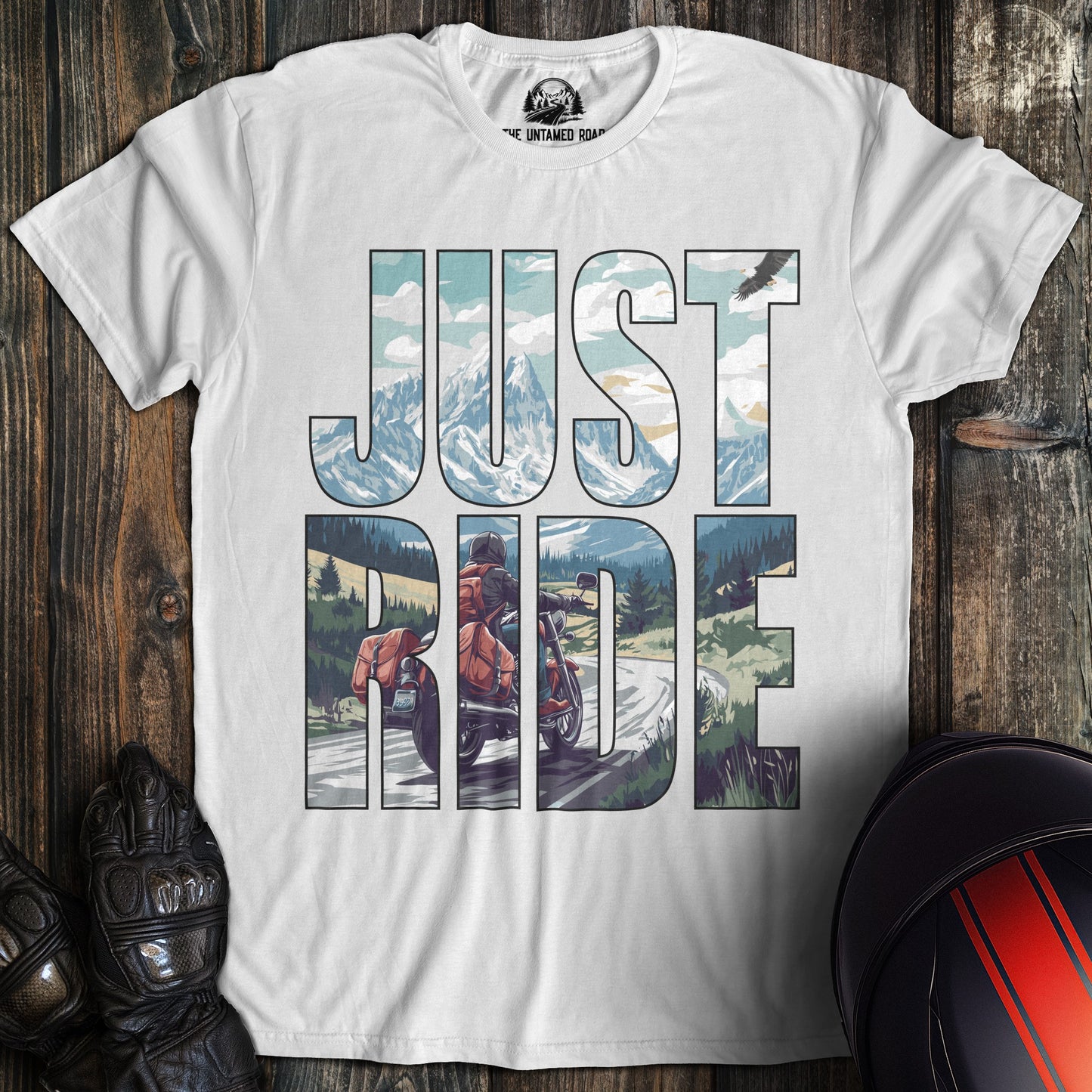 A white colored t-shirt with the words "just ride" printed on the front.