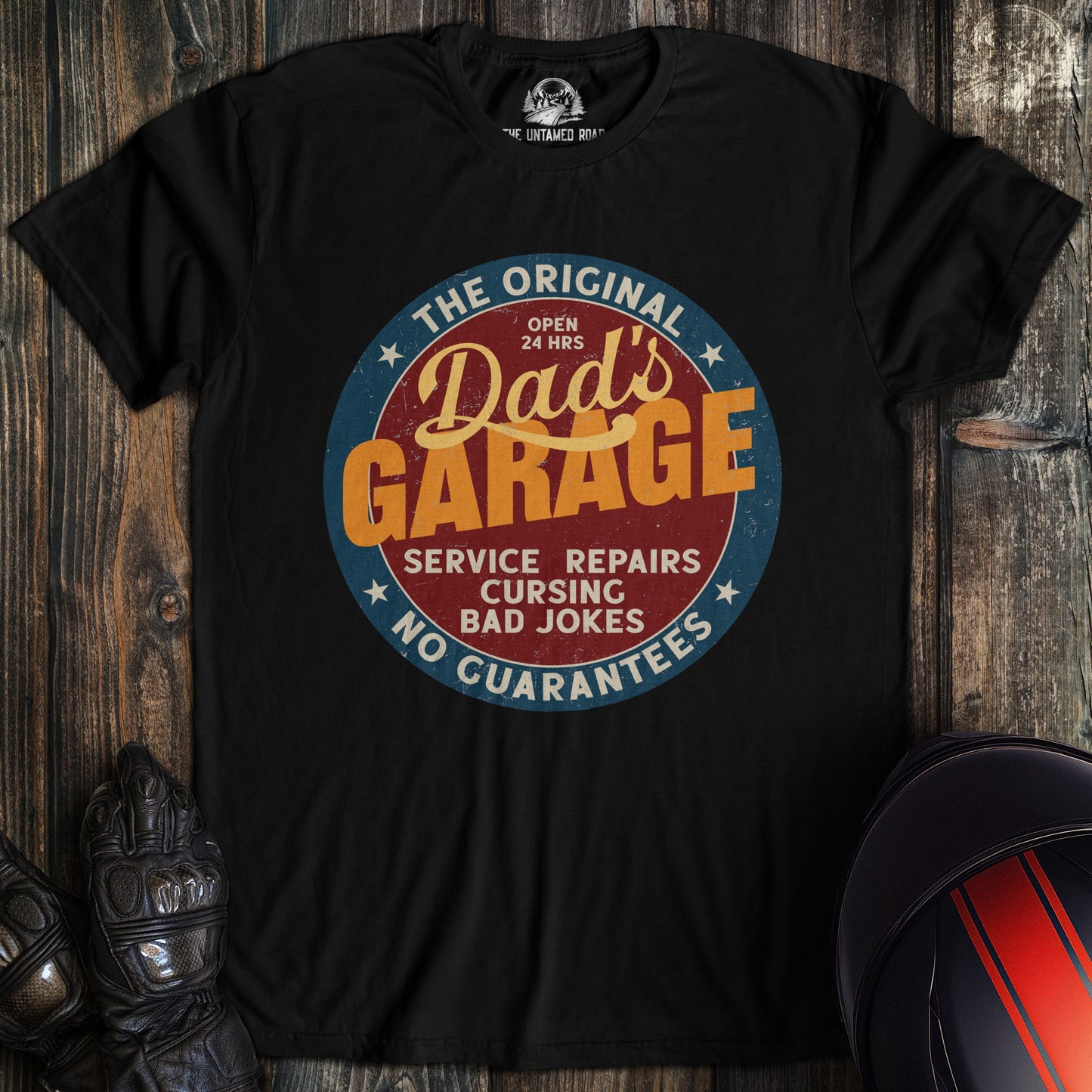 A black colored t-shirt with the words "dads garage" printed on the front.