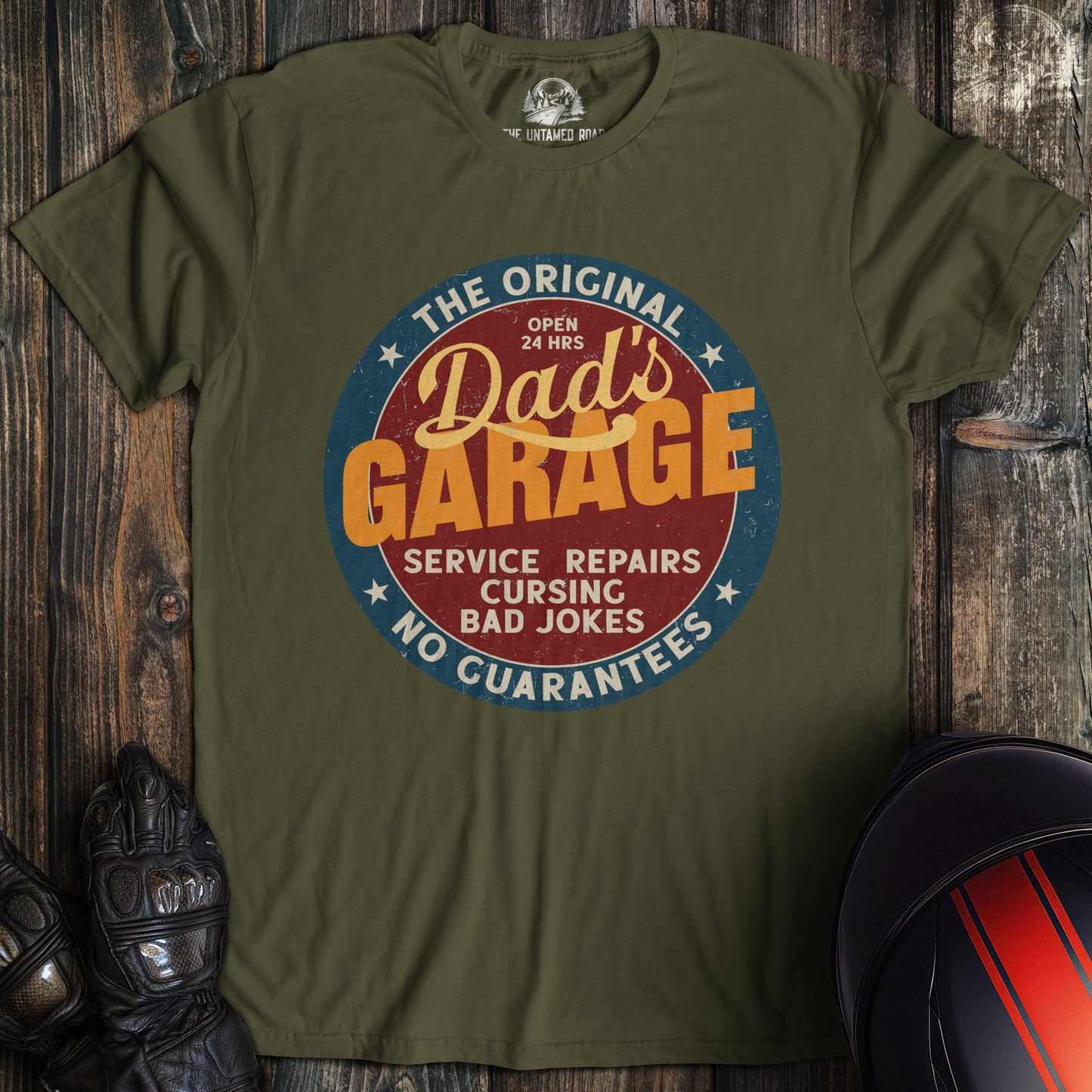 A military green colored t-shirt with the words "dads garage" printed on the front.