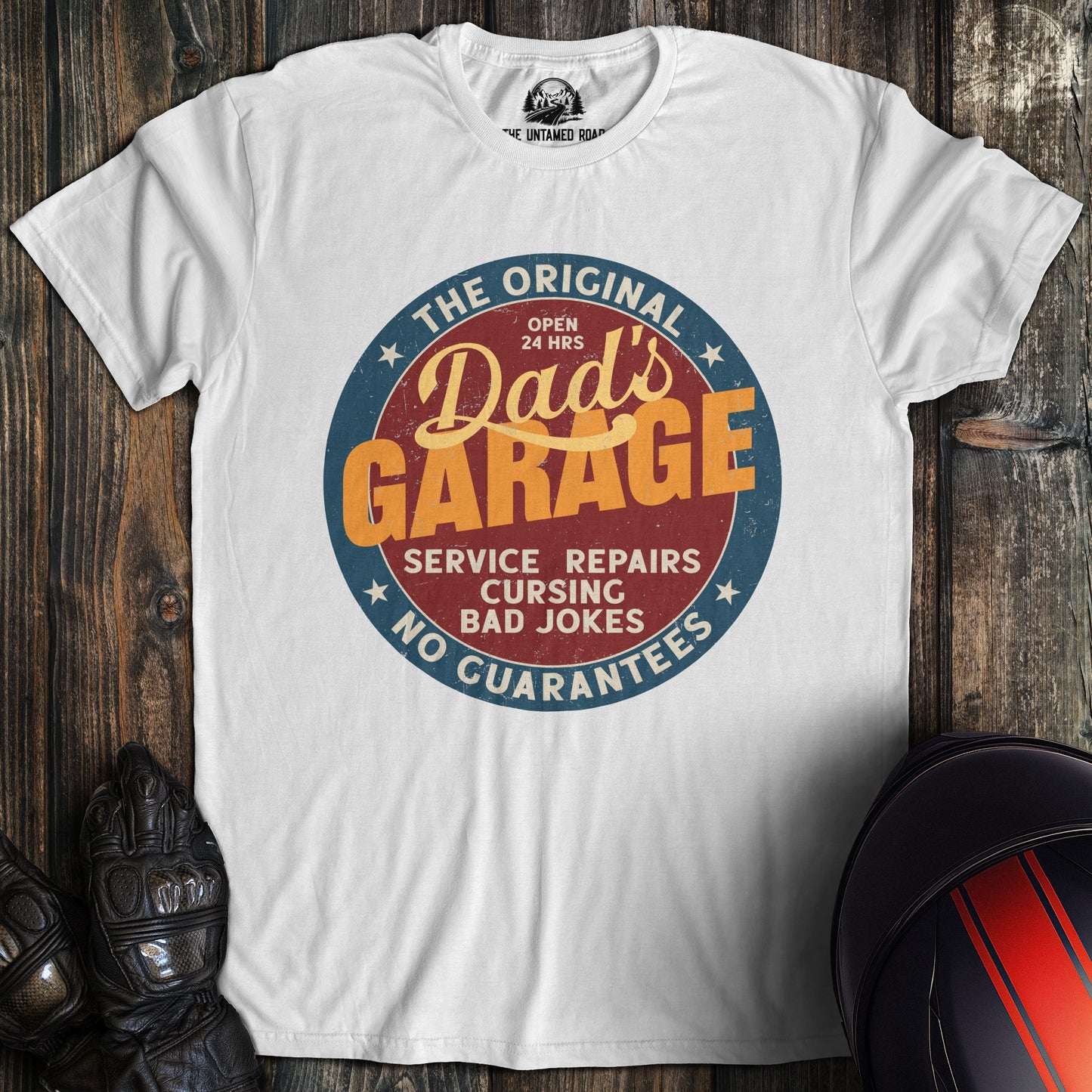 A white colored t-shirt with the words "dads garage" printed on the front.