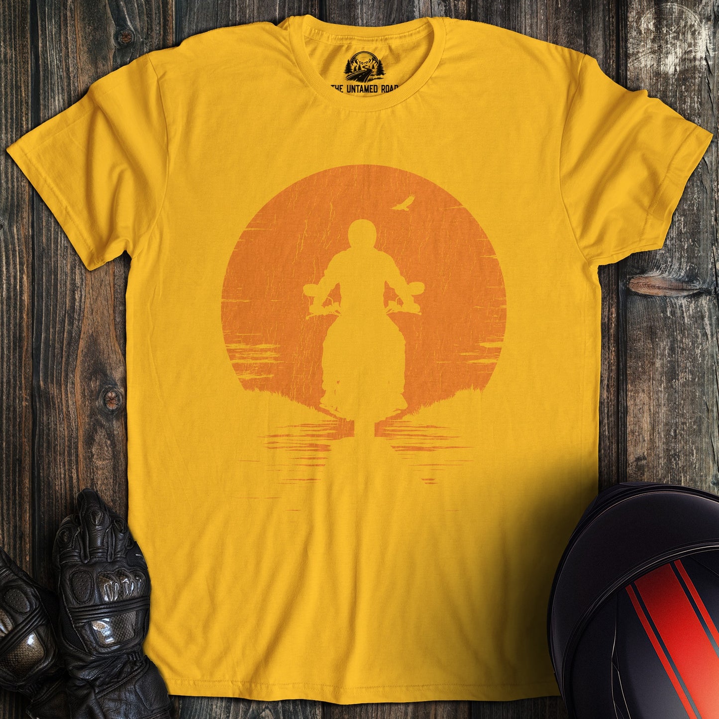 A gold colored t-shirt with the words "sunset" printed on the front.