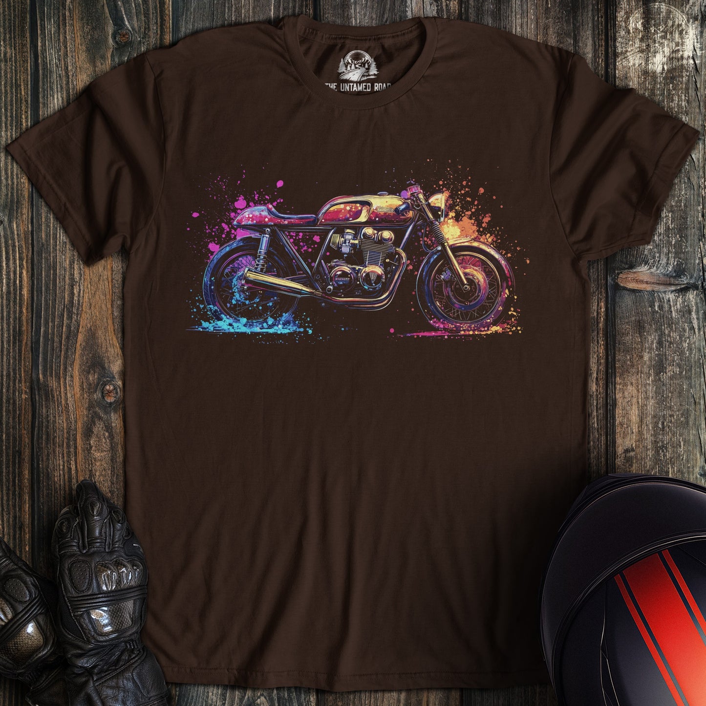 A dark chocolate colored t-shirt with the words "pop art cafe racer" printed on the front.