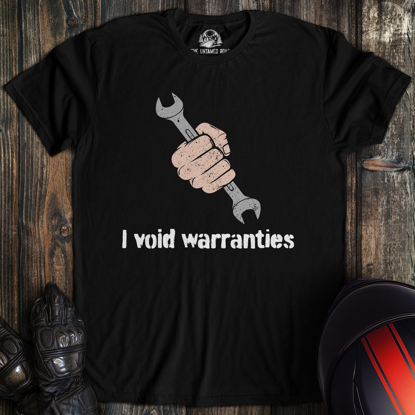 A black colored t-shirt with the words "ivoid warranties" printed on the front.