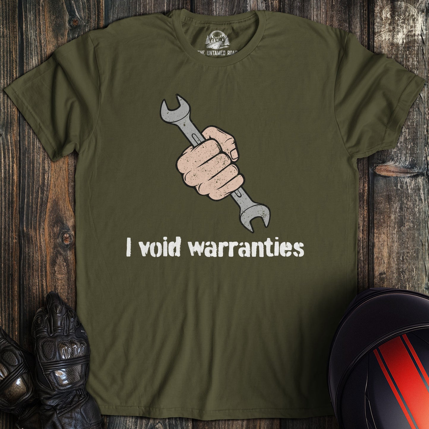 A military green colored t-shirt with the words "ivoid warranties" printed on the front.