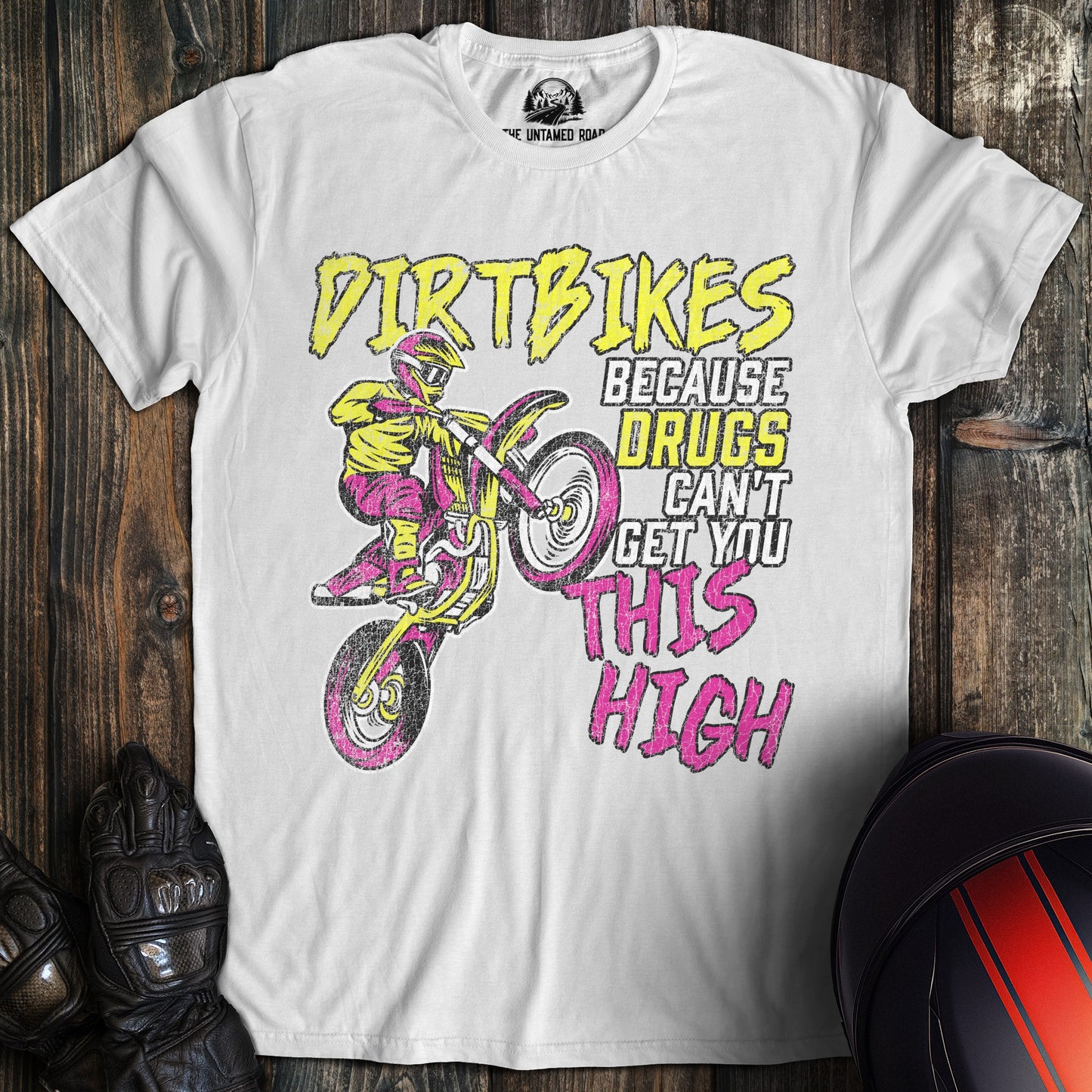 A white colored t-shirt with the words "motocross drugs" printed on the front.