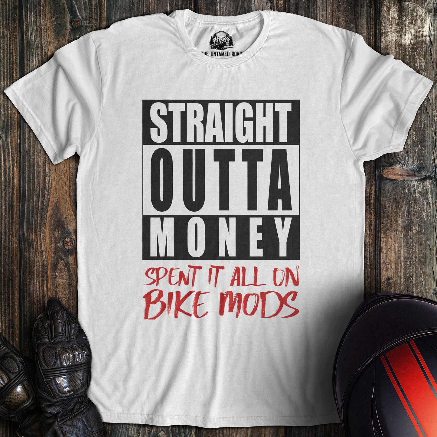 A white colored t-shirt with the words "straight outta money" printed on the front.