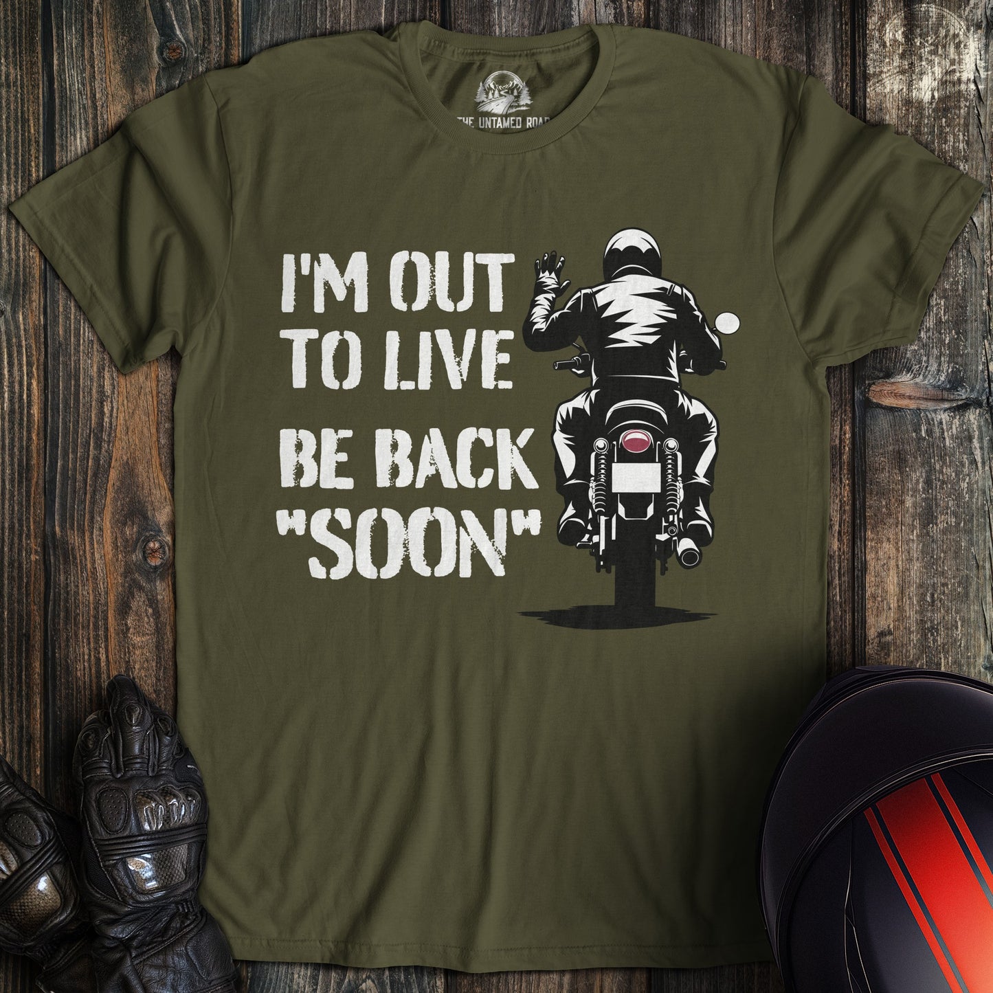 A military green colored t-shirt with the words "out to live be back soon" printed on the front.