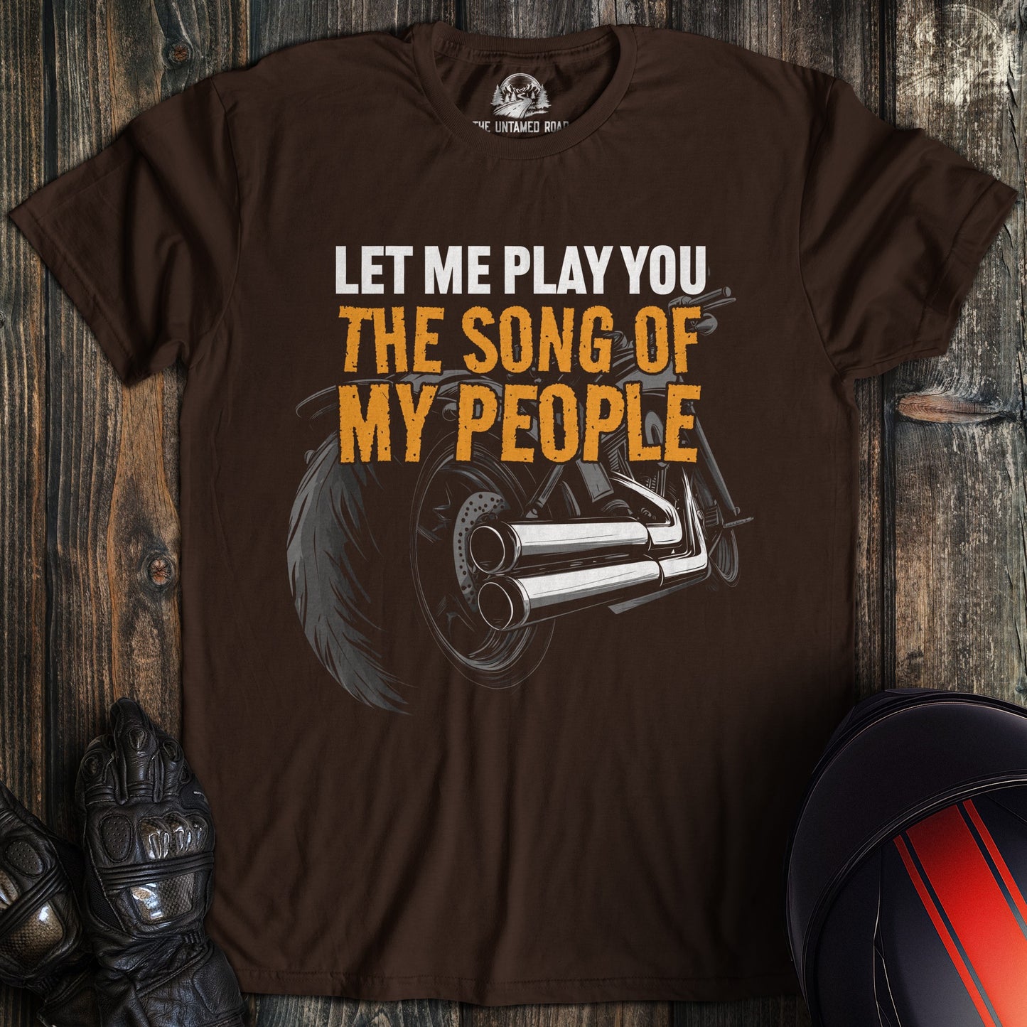 A dark chocolate colored t-shirt with the words "song of my people" printed on the front.