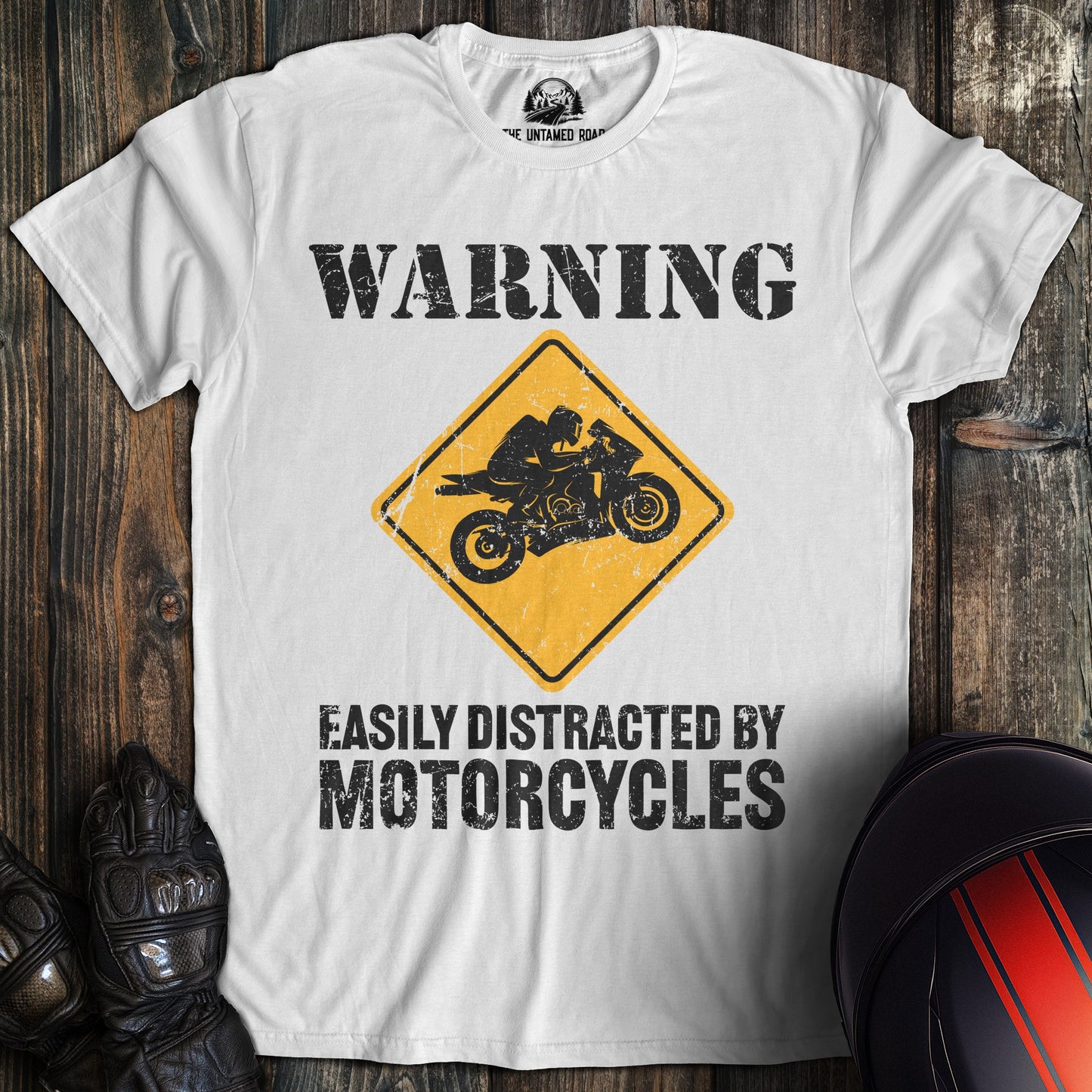 A white colored t-shirt with the words "easily distracted" printed on the front.