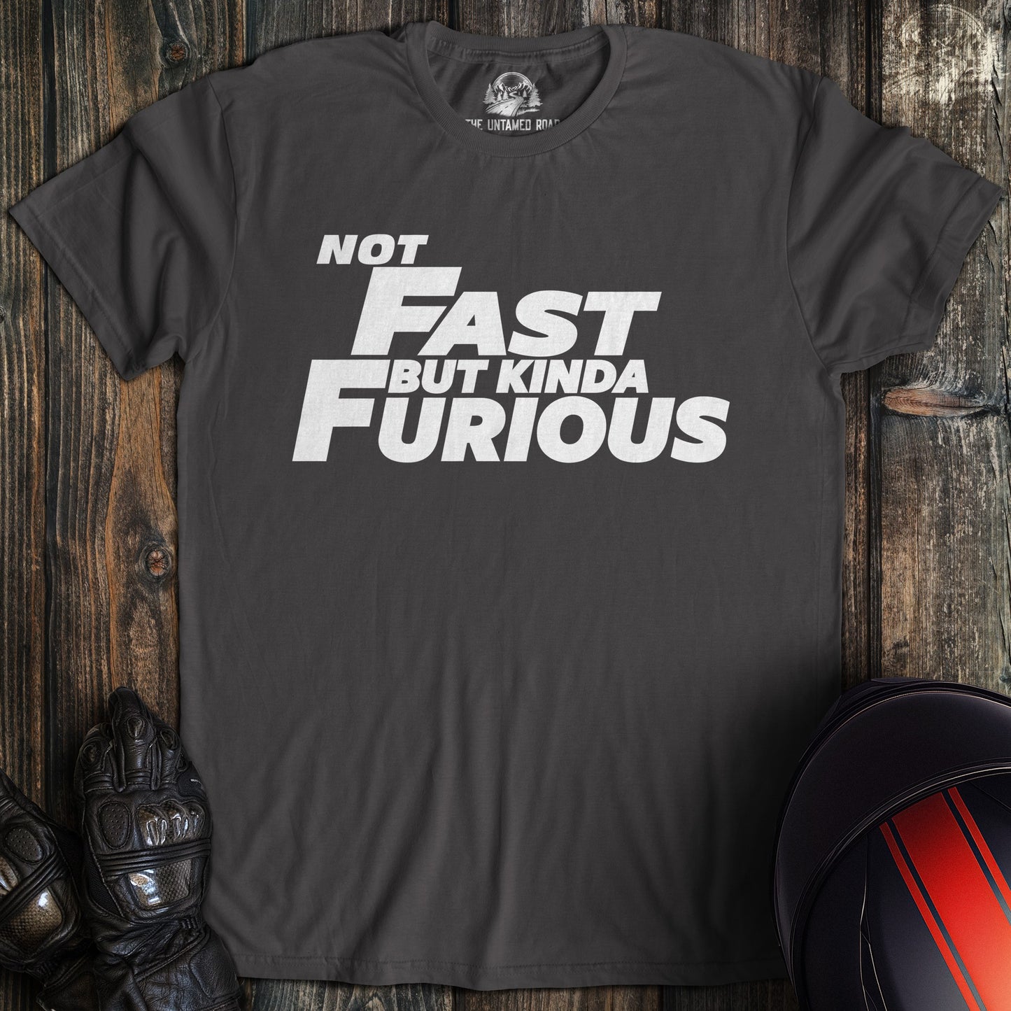 A charcoal colored t-shirt with the words "not fast kinda furious minimal" printed on the front.