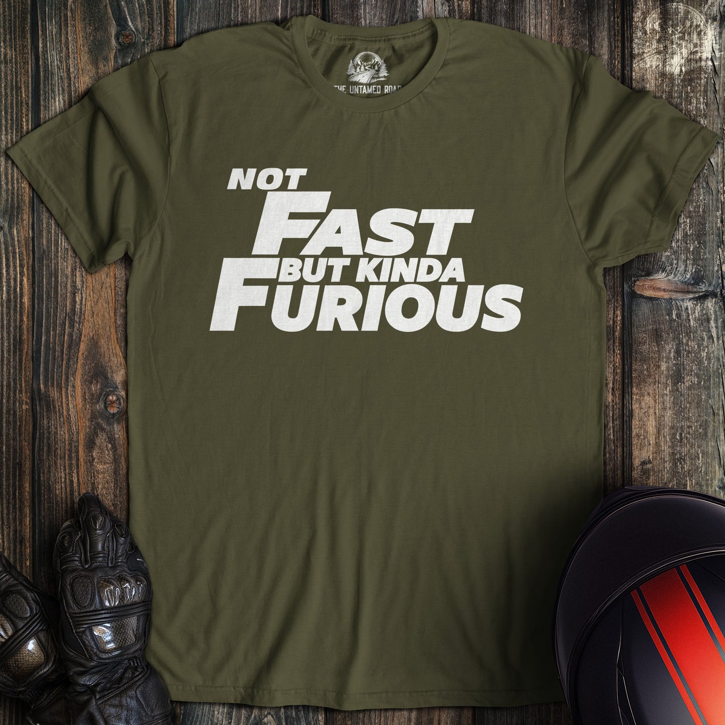 A military green colored t-shirt with the words "not fast kinda furious minimal" printed on the front.