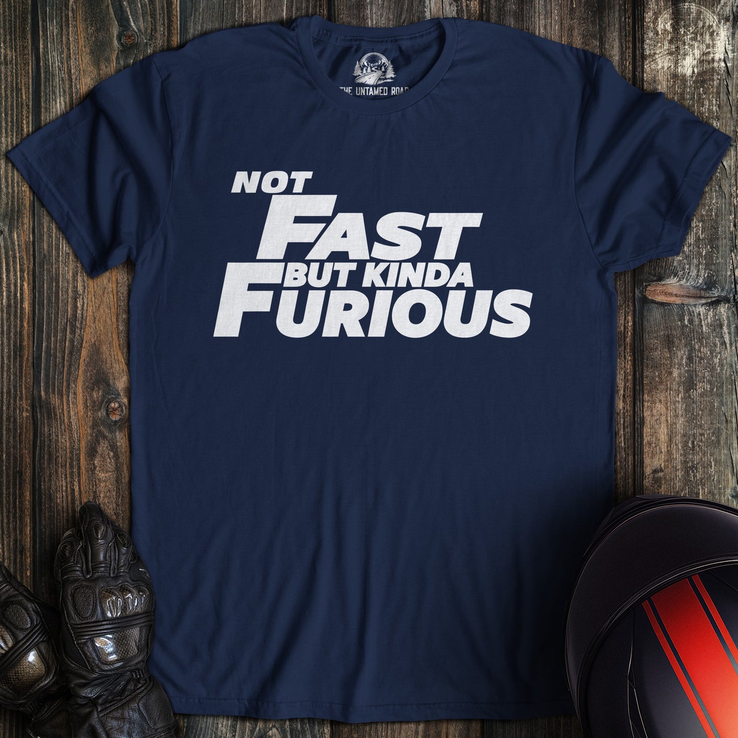 A navy colored t-shirt with the words "not fast kinda furious minimal" printed on the front.