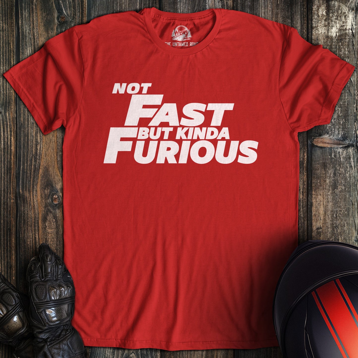 A red colored t-shirt with the words "not fast kinda furious minimal" printed on the front.