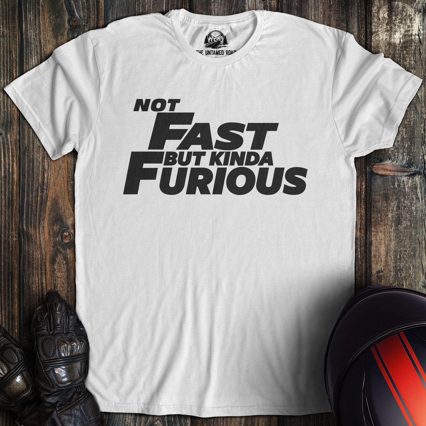 A white colored t-shirt with the words "not fast kinda furious minimal" printed on the front.