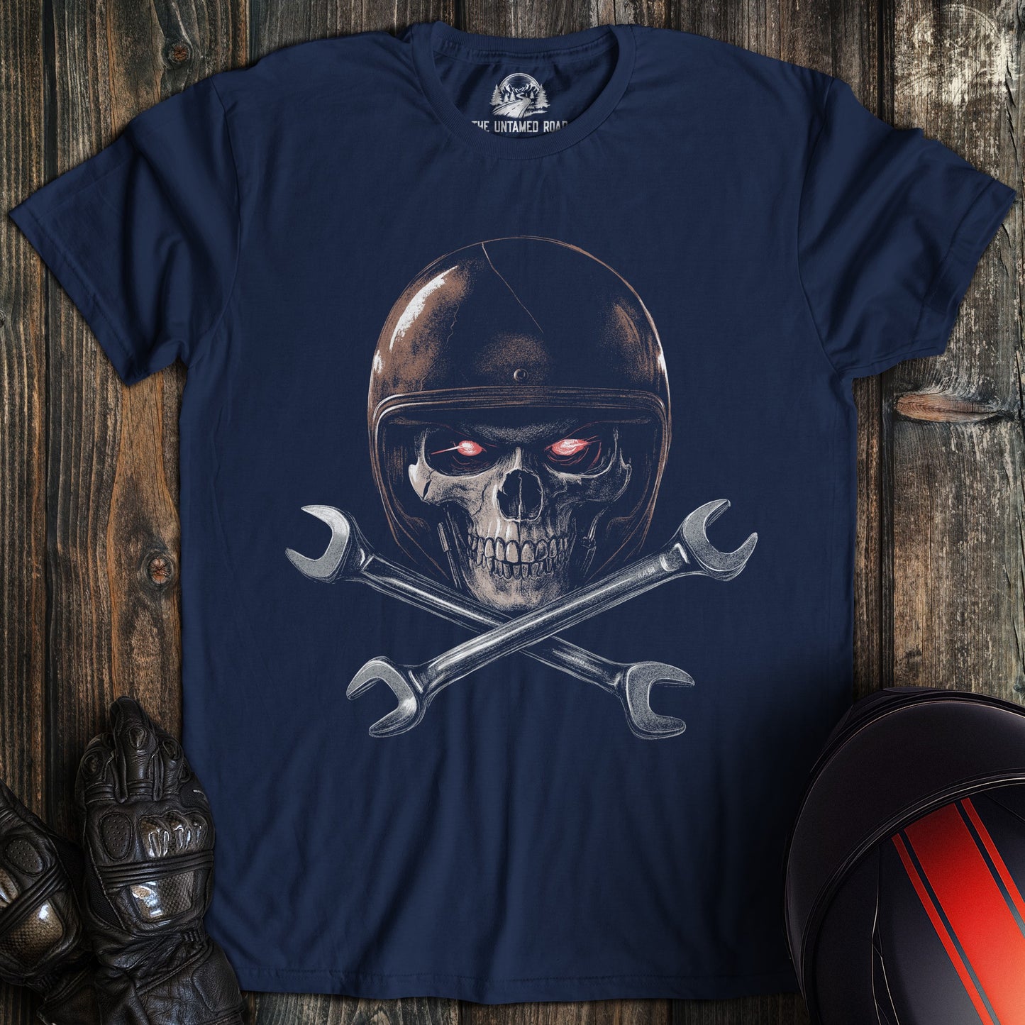 A navy colored t-shirt with the words "skull and wrenches" printed on the front.