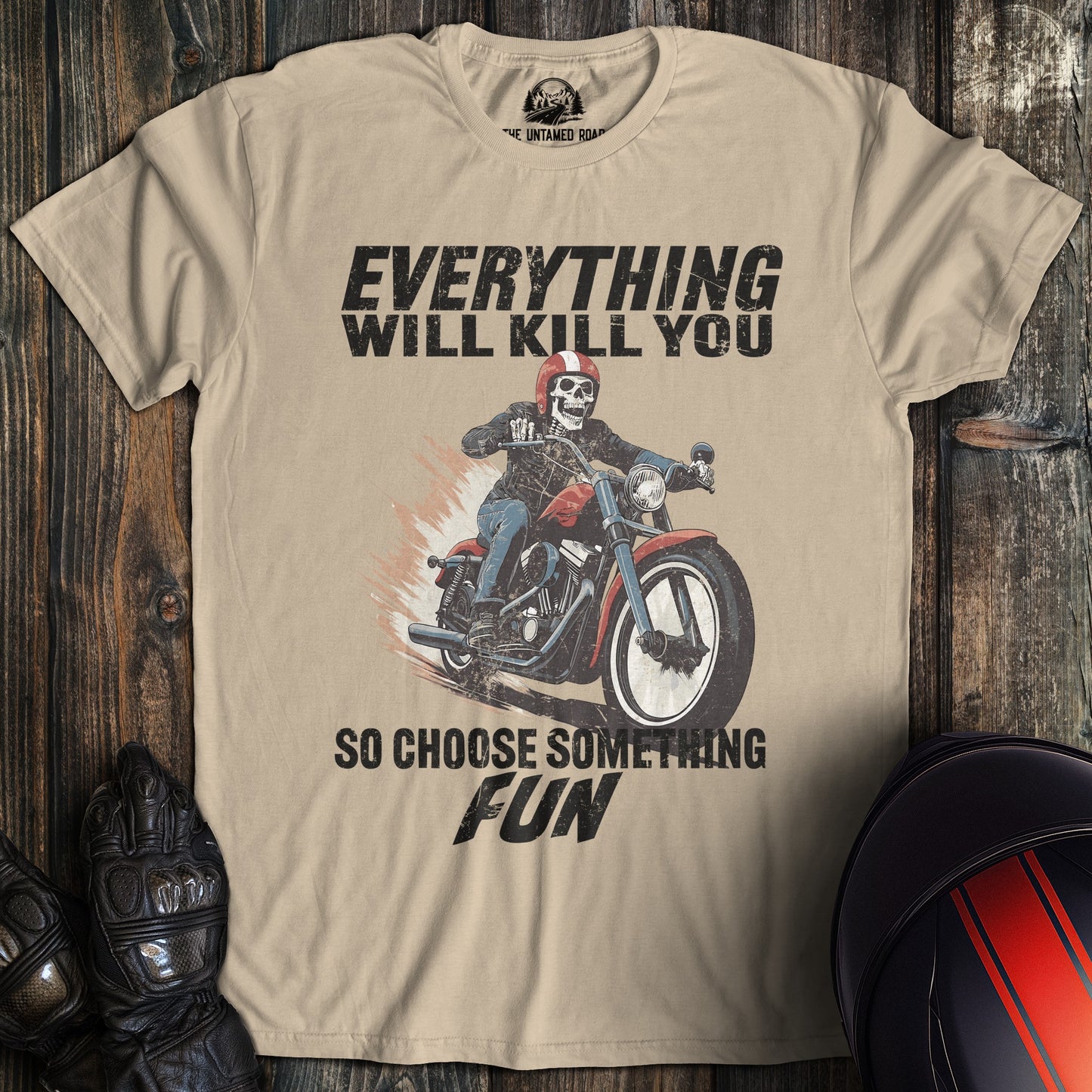 A sand colored t-shirt with the words "everything will kill you" printed on the front.