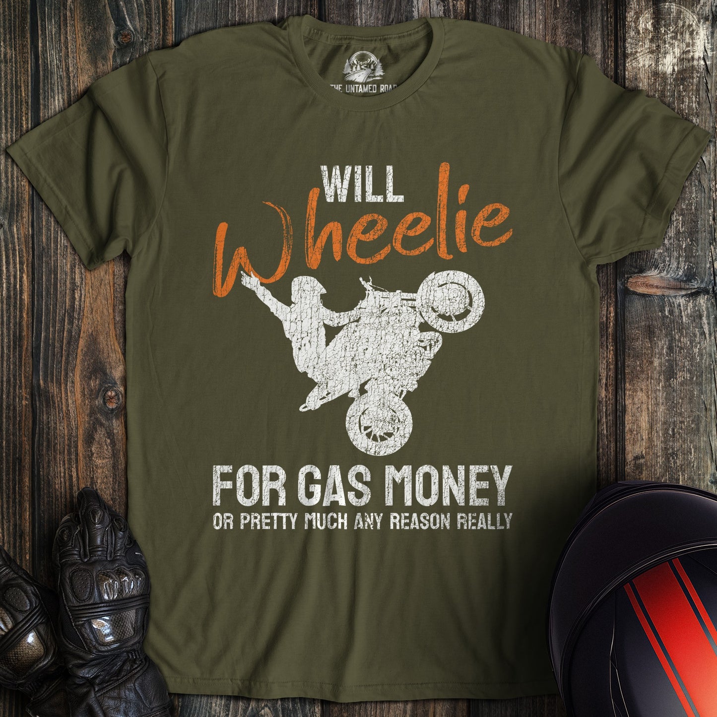 A military green colored t-shirt with the words "wheelie for money" printed on the front.