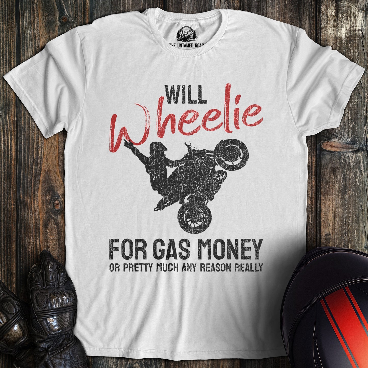 A white colored t-shirt with the words "wheelie for money" printed on the front.