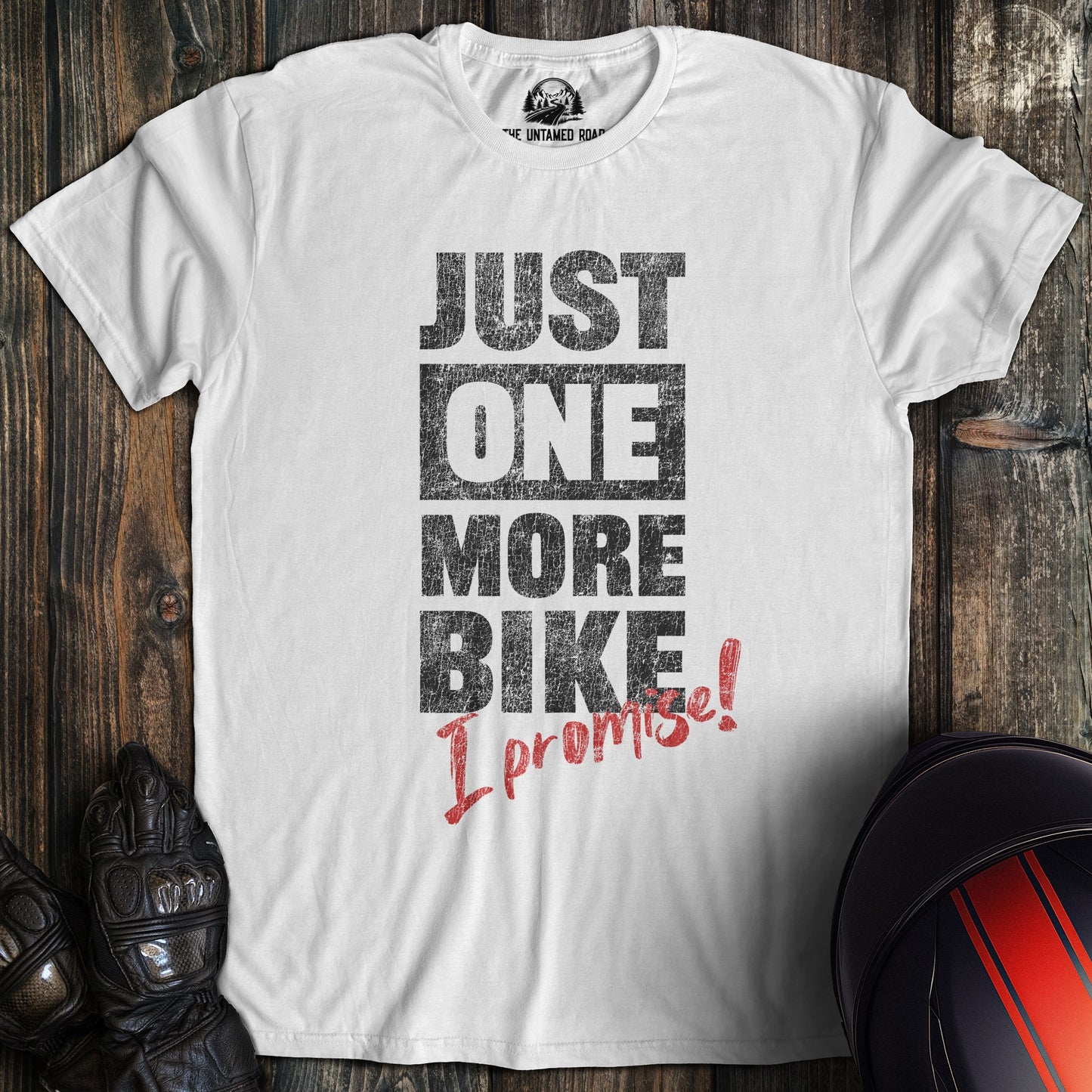 A white colored t-shirt with the words "just one more bike" printed on the front.