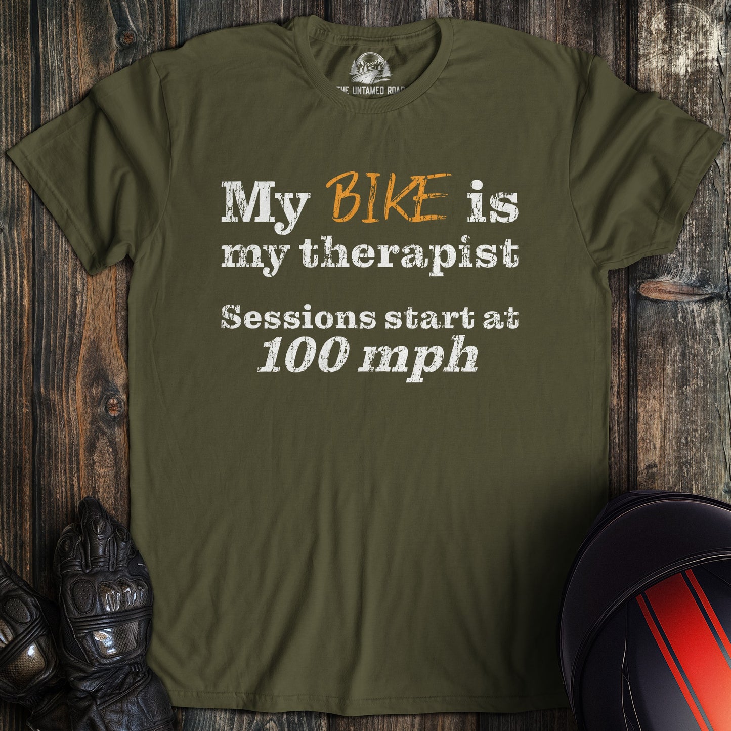 A military green colored t-shirt with the words "bike is therapist" printed on the front.