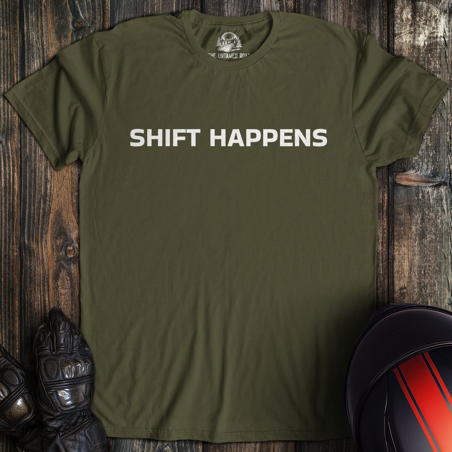 A military green colored t-shirt with the words "shift happens" printed on the front.