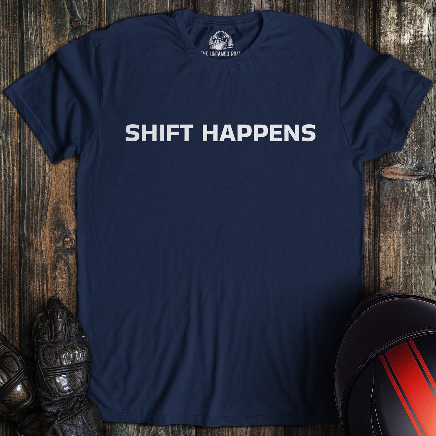 A navy colored t-shirt with the words "shift happens" printed on the front.