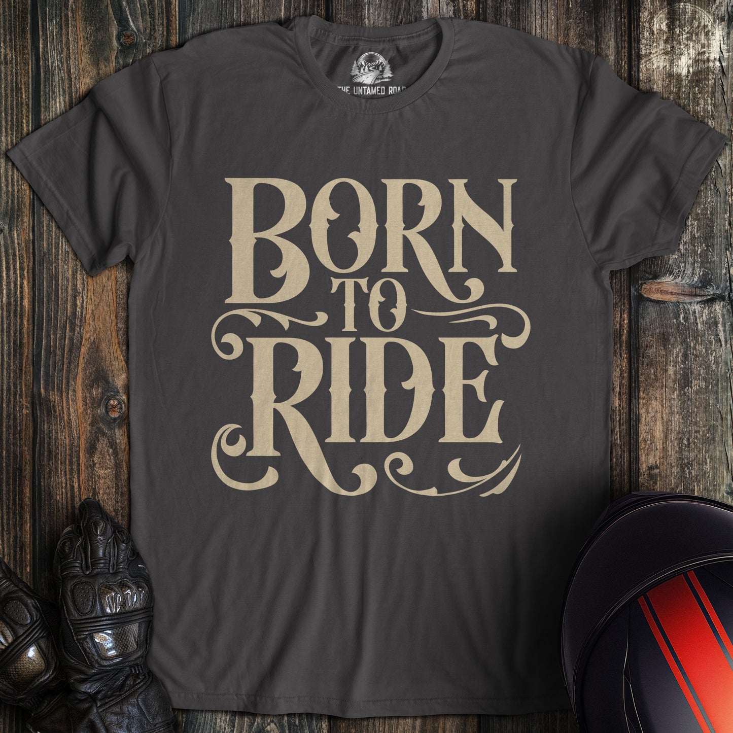 A charcoal colored t-shirt with the words "born to ride gothic" printed on the front.