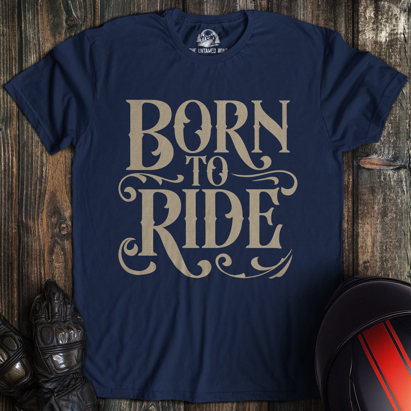 A navy colored t-shirt with the words "born to ride gothic" printed on the front.