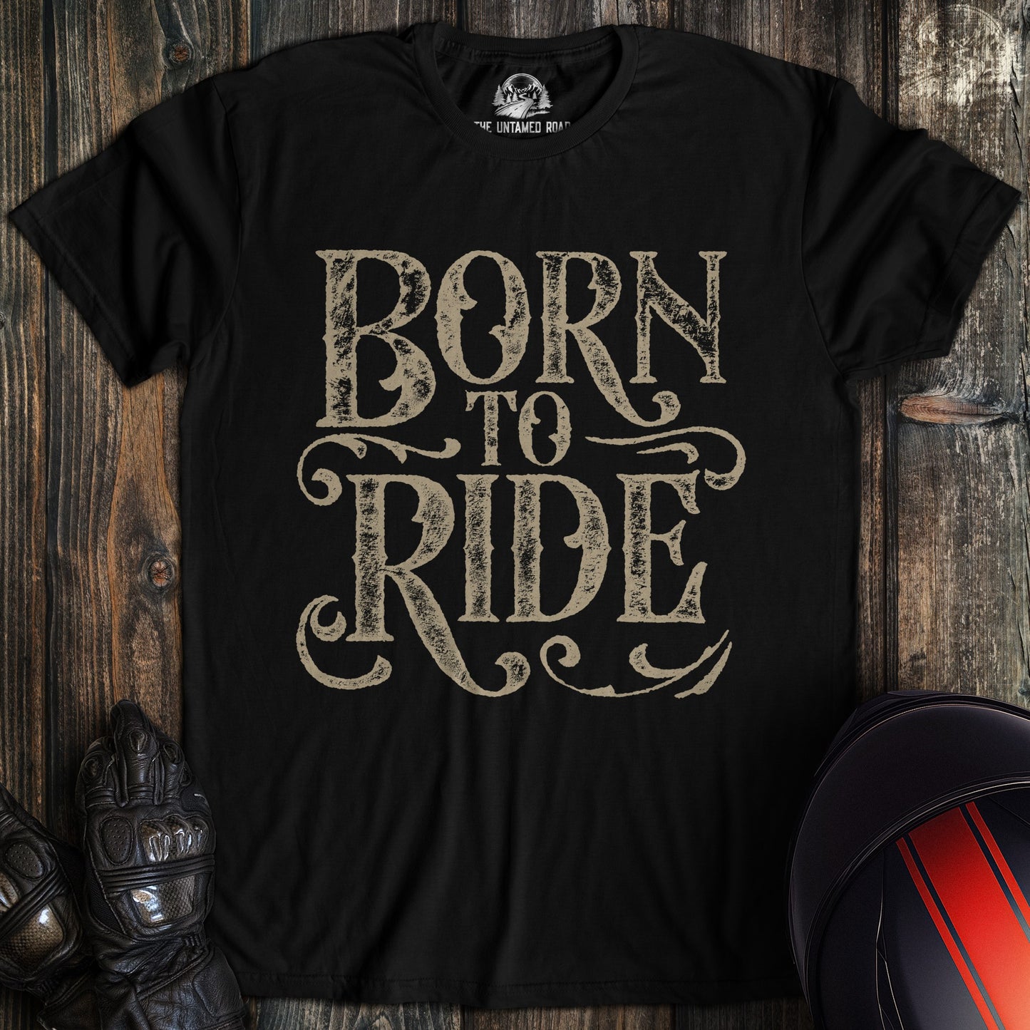 A black colored t-shirt with the words "born to ride gothic grunge" printed on the front.