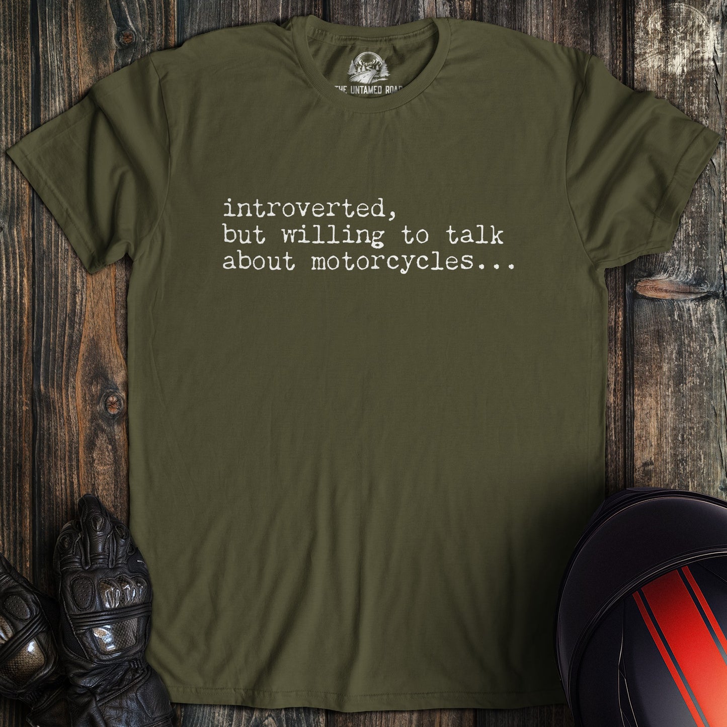 A military green colored t-shirt with the words "introverted but willing to talk" printed on the front.