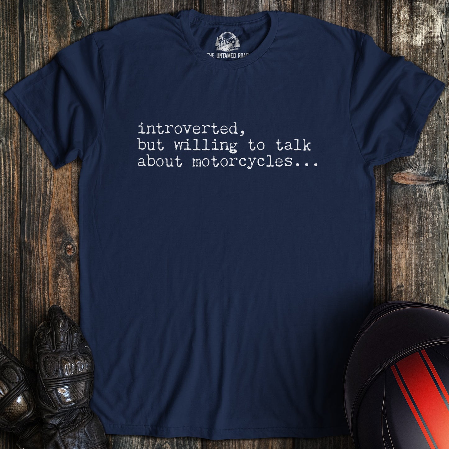 A navy colored t-shirt with the words "introverted but willing to talk" printed on the front.