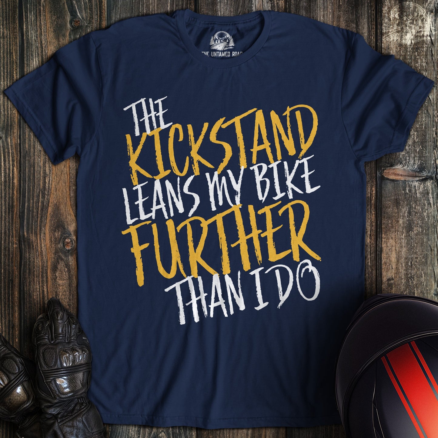 A navy colored t-shirt with the words "kickstand leans further" printed on the front.