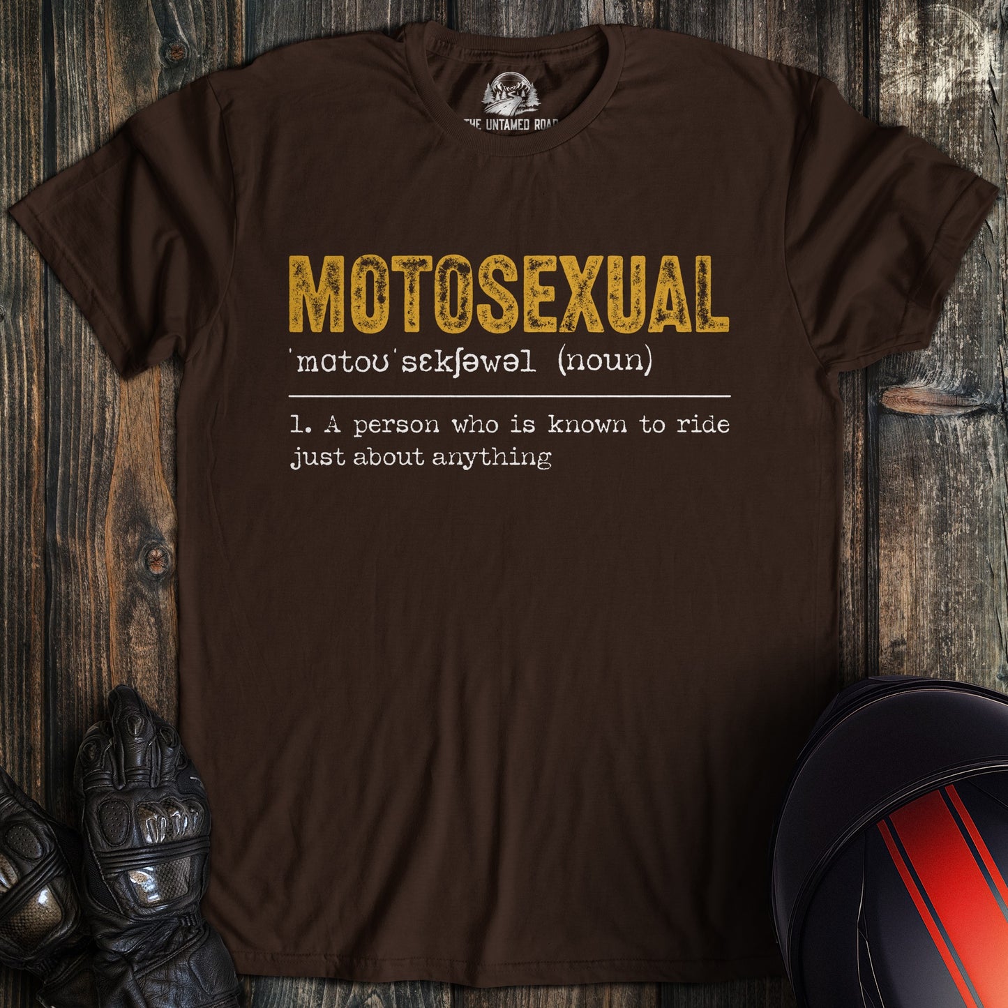 A dark brown t-shirt featuring a dictionary-style definition for the word 'MOTOSEXUAL' in yellow and white text.