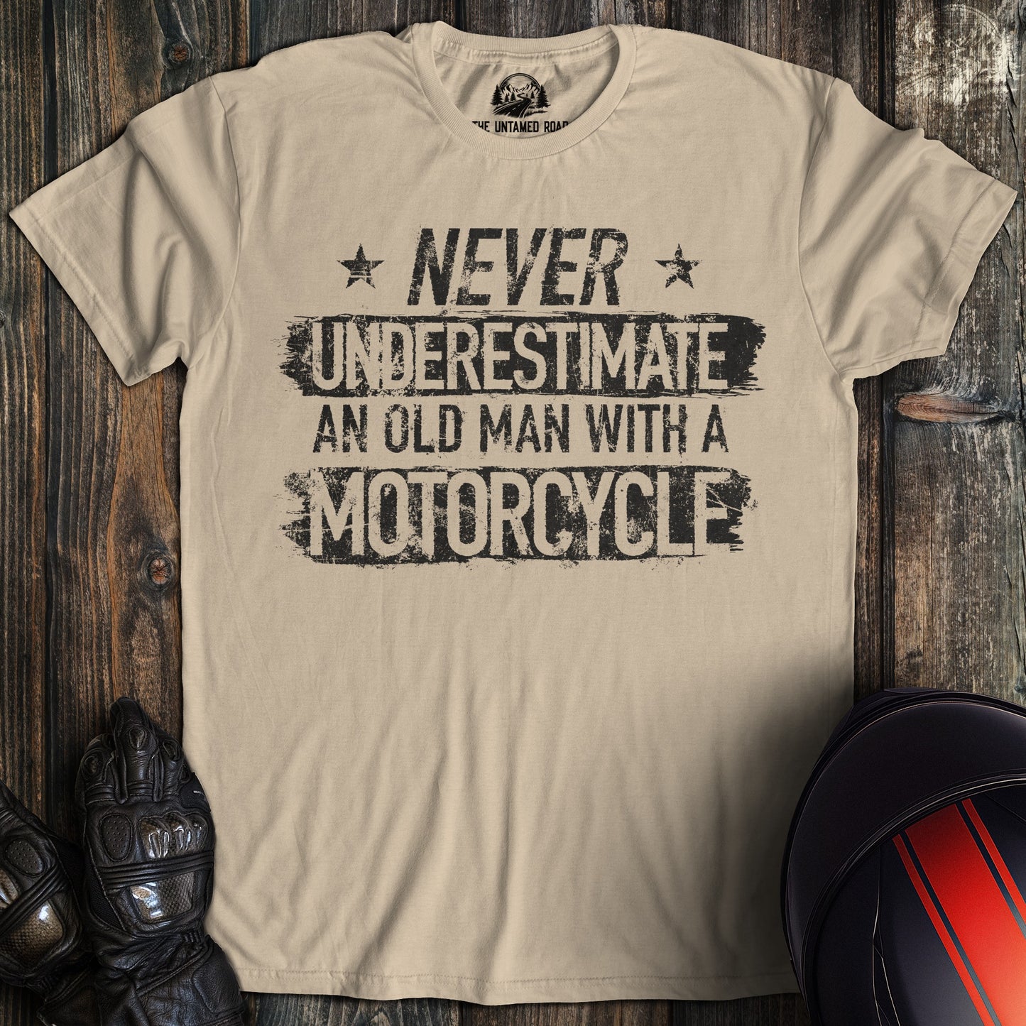 A sand colored t-shirt with the words "old man motorcycle" printed on the front.