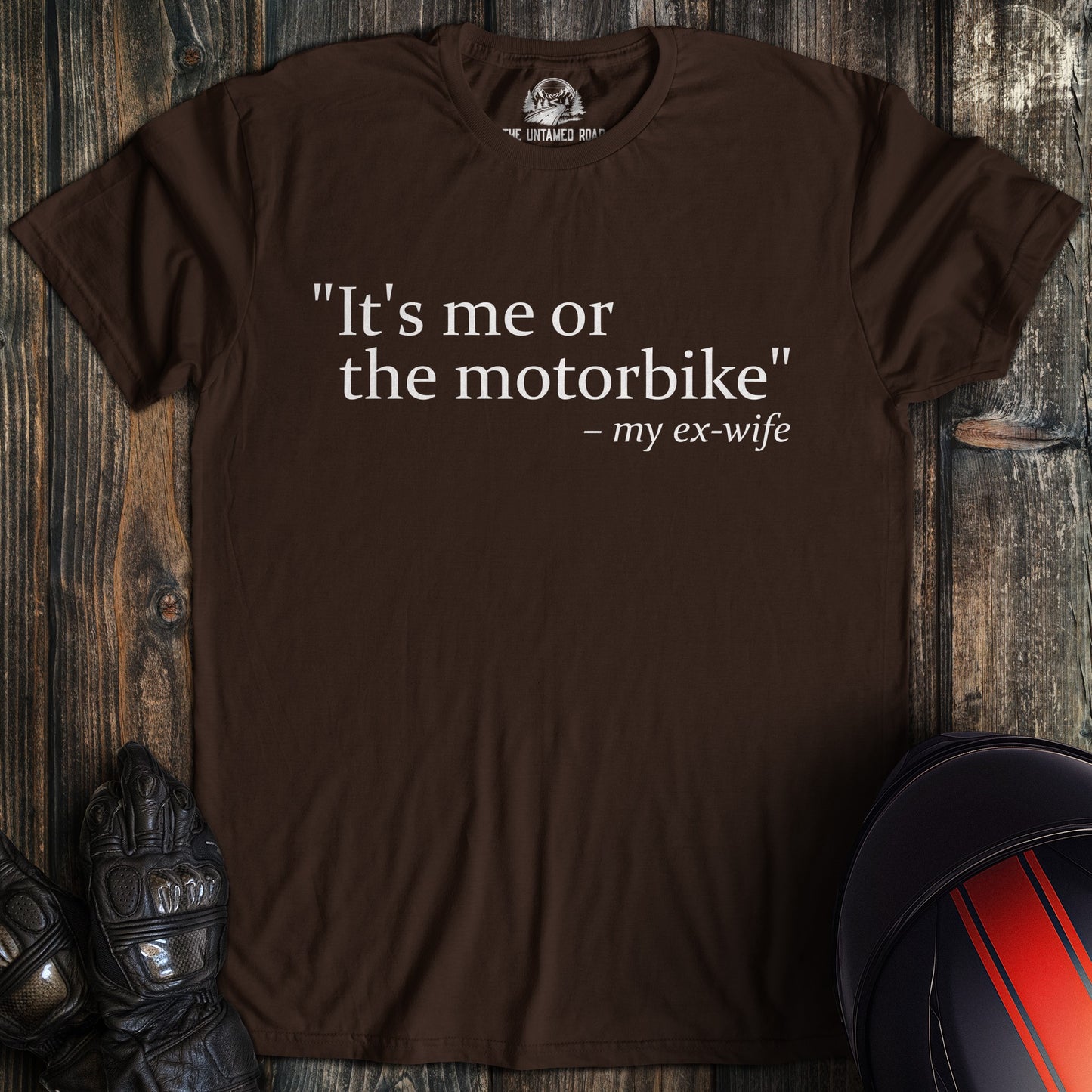 A dark chocolate colored t-shirt with the words "me or motorbike" printed on the front.