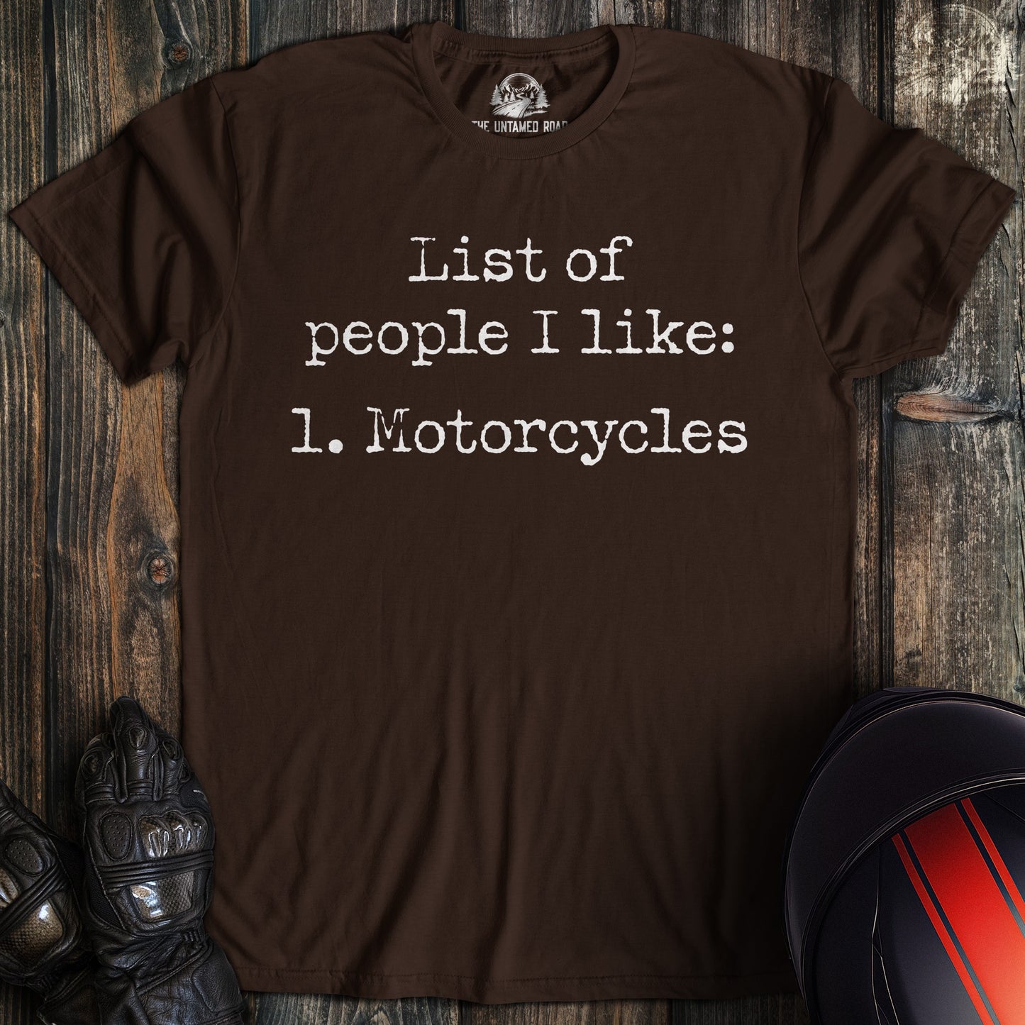 A dark chocolate colored t-shirt with the words "list of people ilike" printed on the front.