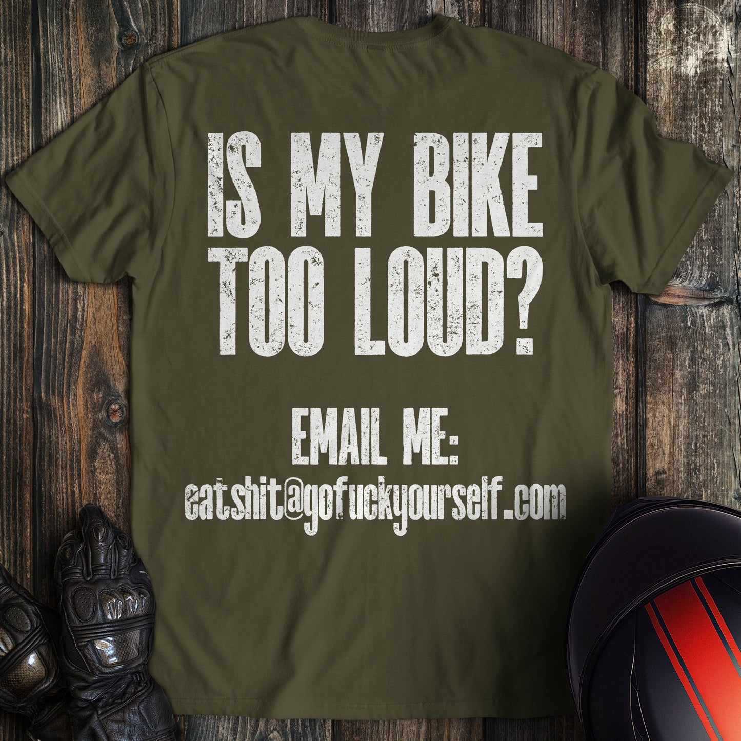 A military green colored t-shirt with the words "loud bike complaint" printed on the back.