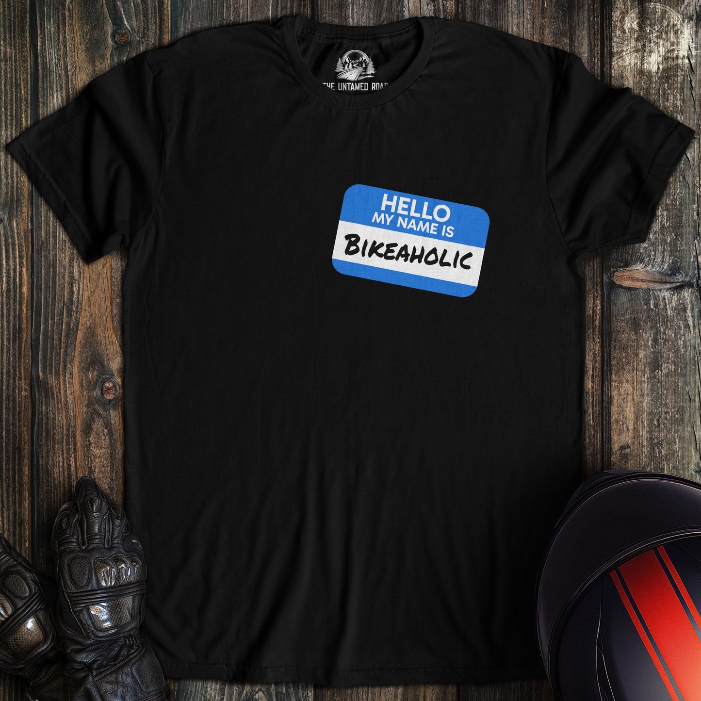 A black colored t-shirt with the words "bikeaholic nametag" printed on the front.