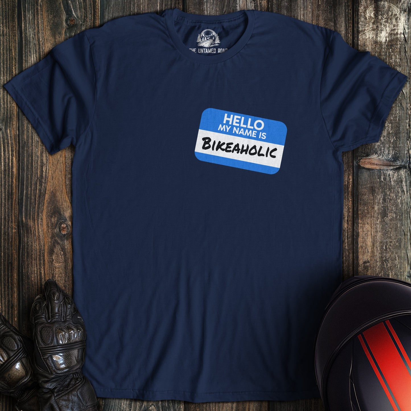 A navy colored t-shirt with the words "bikeaholic nametag" printed on the front.