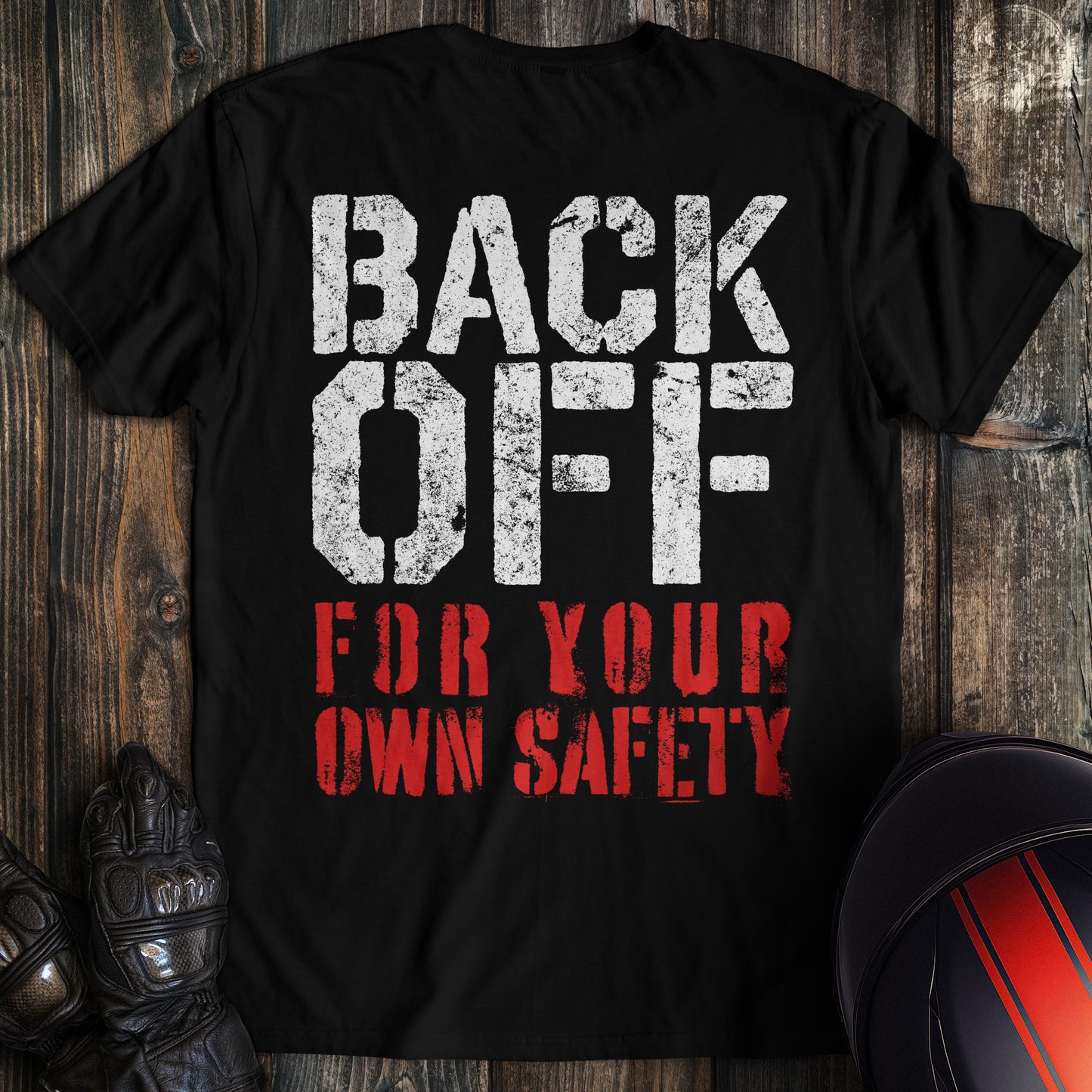 A black colored t-shirt with the words "back off for your safety" printed on the back.