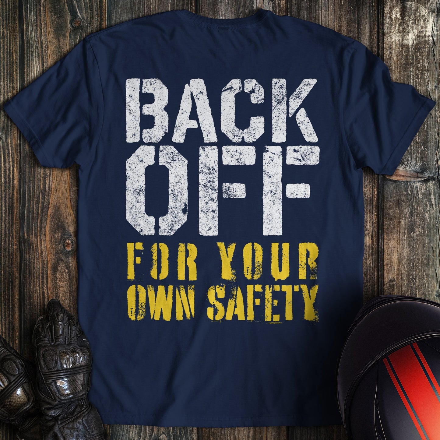 A navy colored t-shirt with the words "back off for your safety" printed on the back.