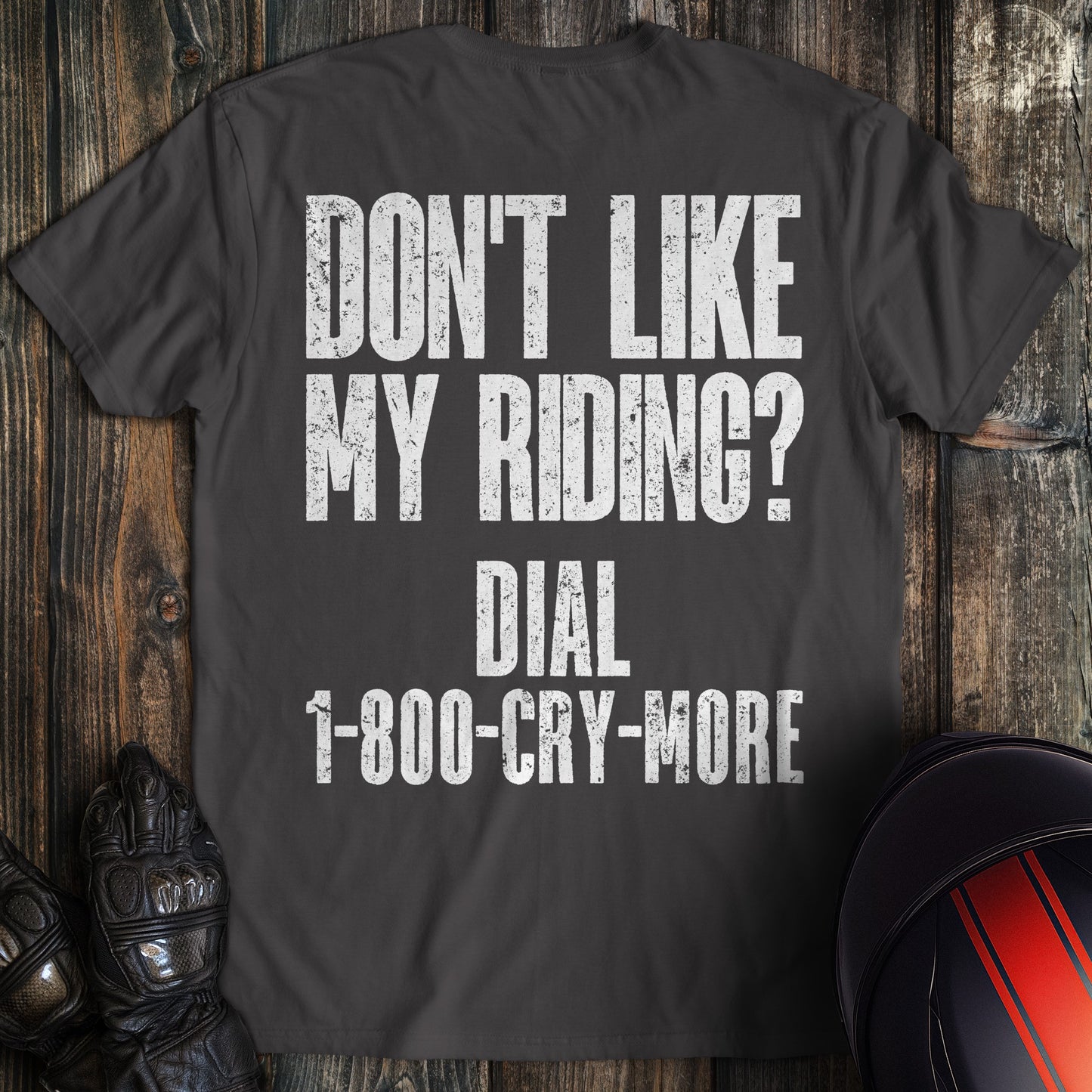 A charcoal colored t-shirt with the words "riding complaint clean" printed on the back.