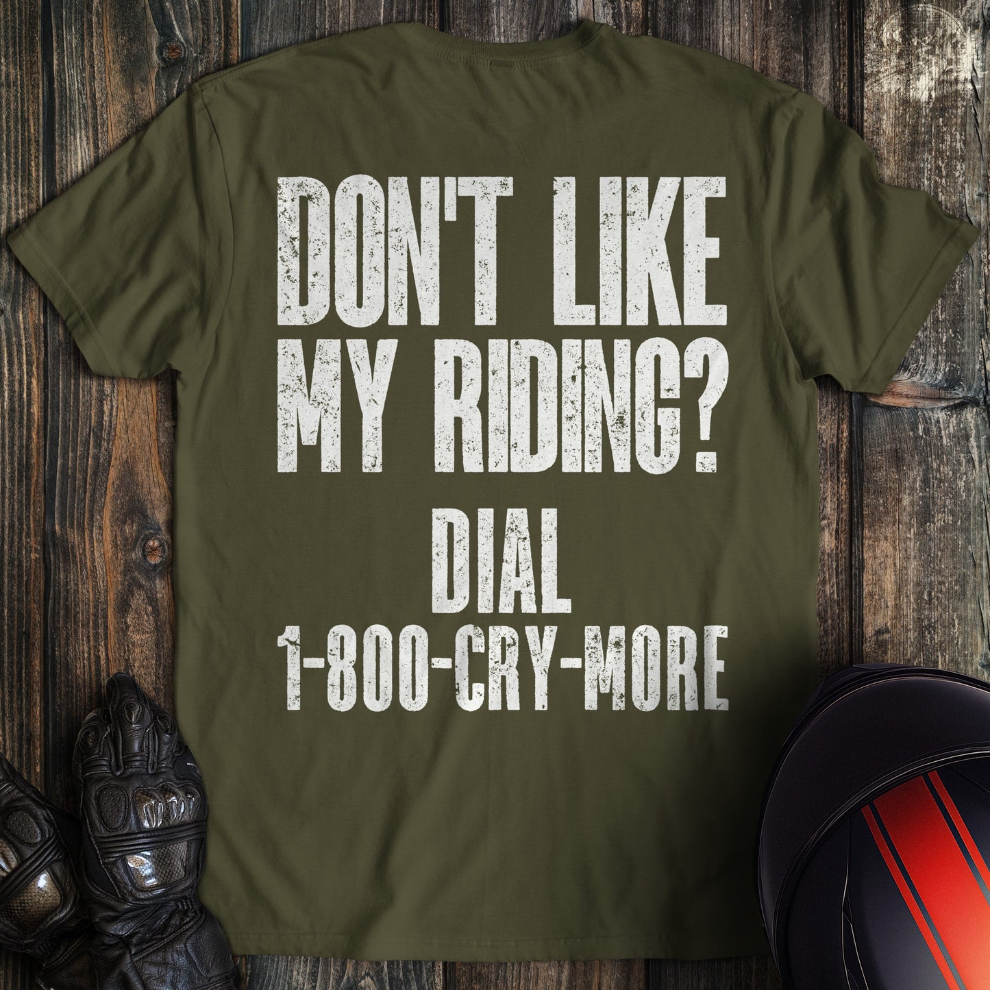 A military green colored t-shirt with the words "riding complaint clean" printed on the back.